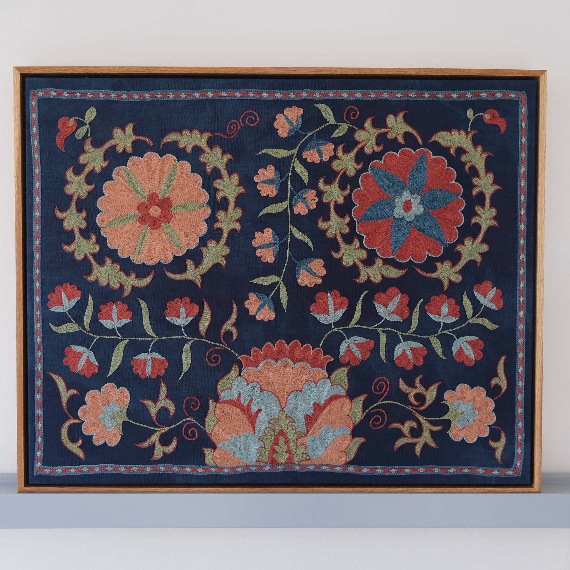 Framed suzani, embroidered textile art, wooden frame, navy blue with floral motifs