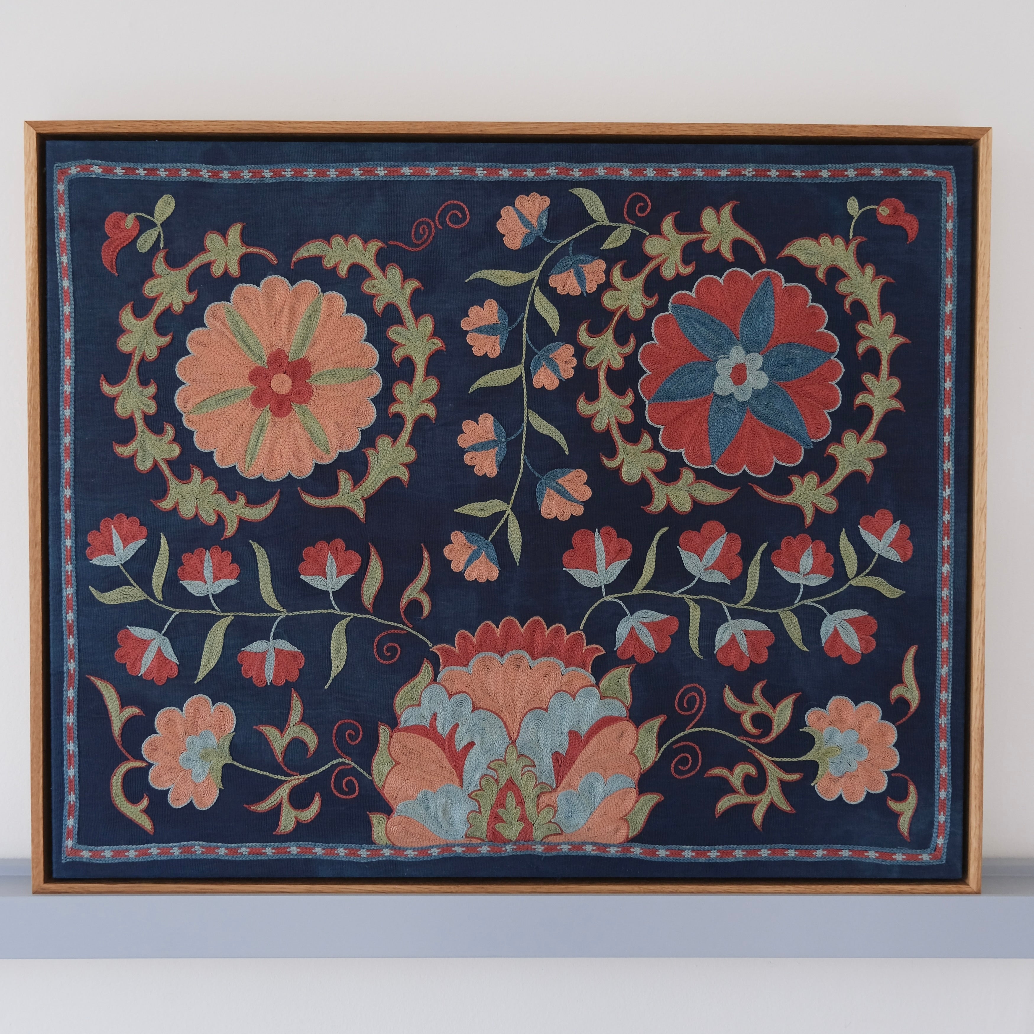 Framed suzani, embroidered textile art, wooden frame, navy blue with floral motifs