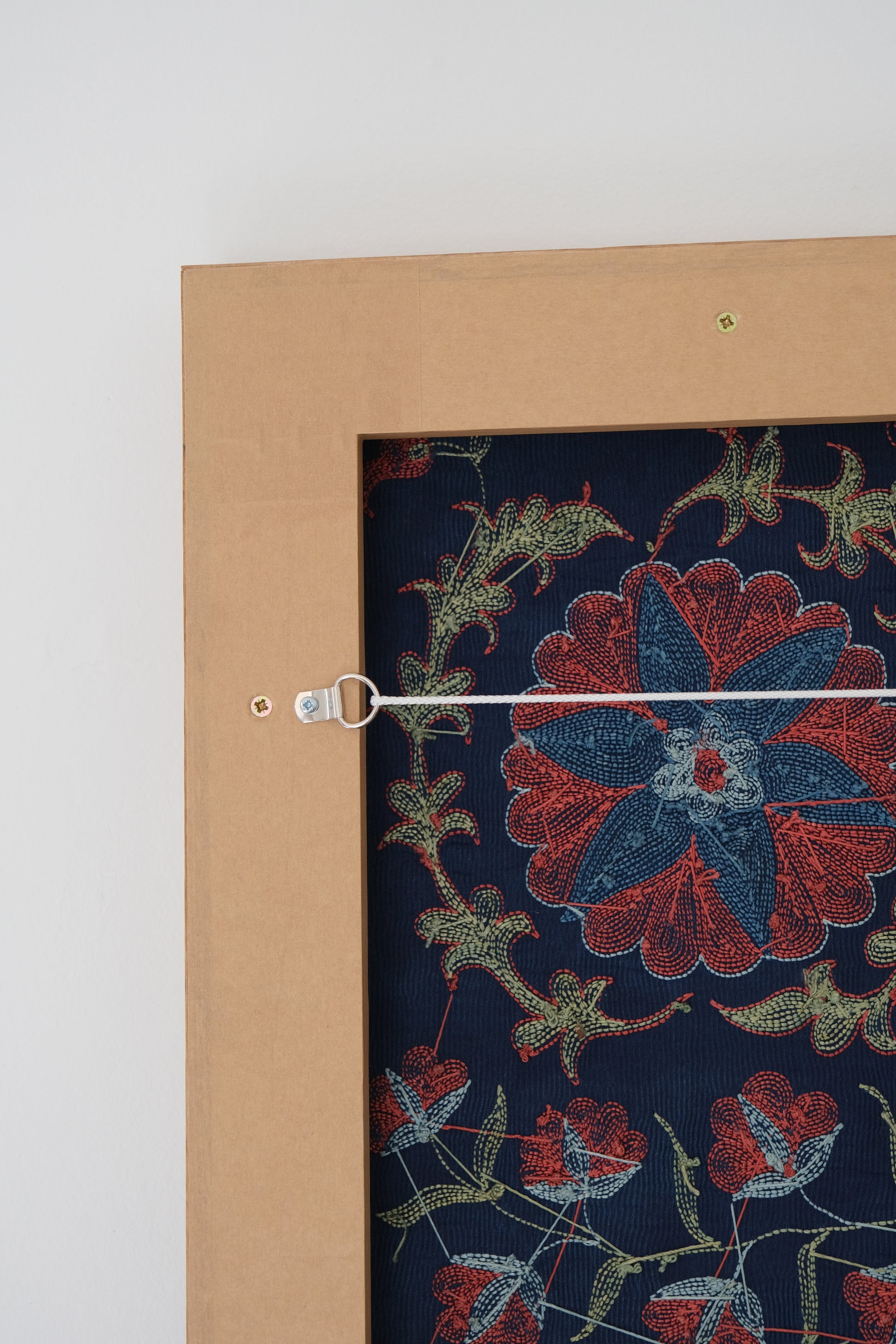 Framed suzani, embroidered textile art, wooden frame, navy blue with floral motifs, backside