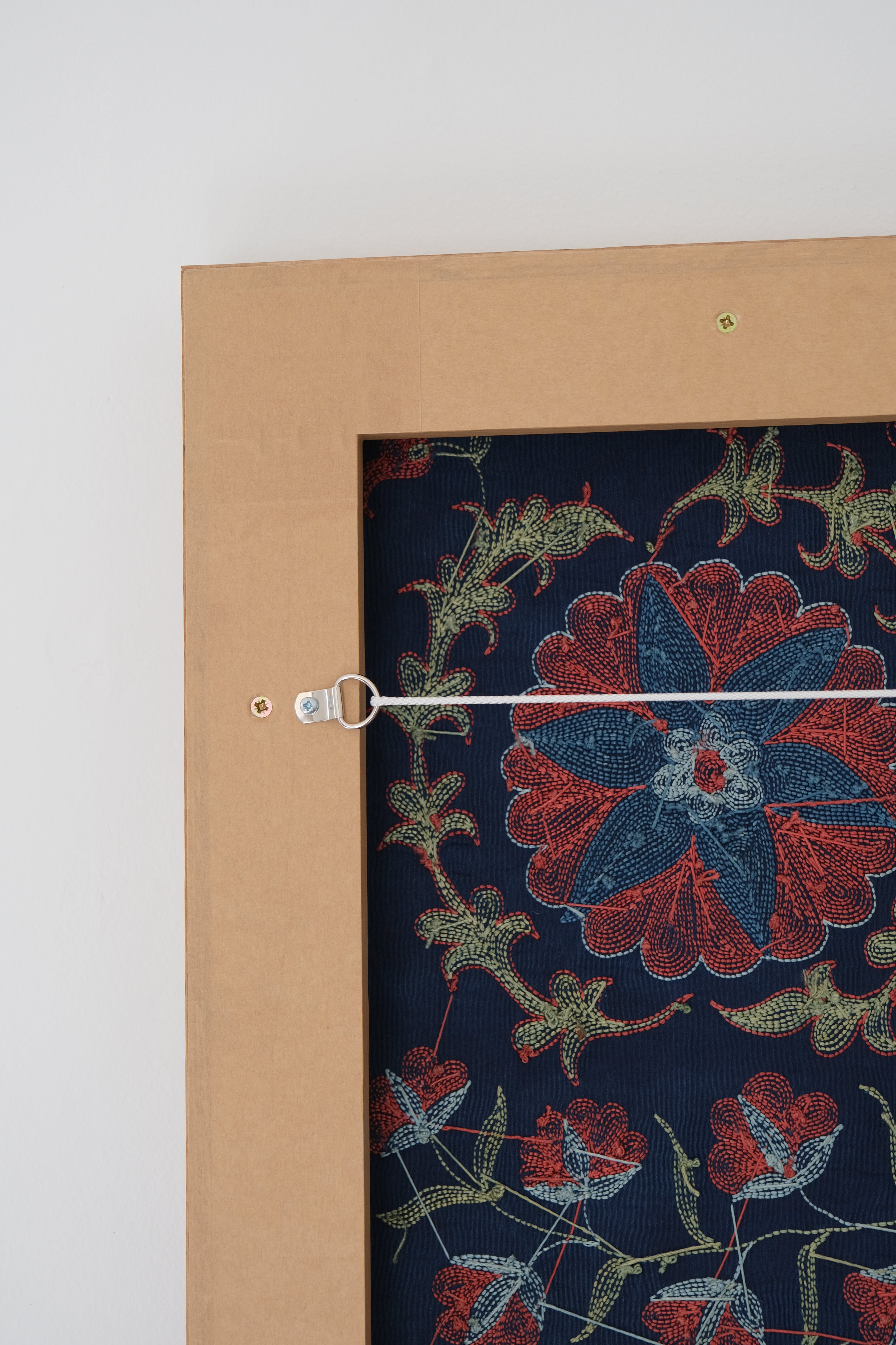 Framed suzani, embroidered textile art, wooden frame, navy blue with floral motifs, backside