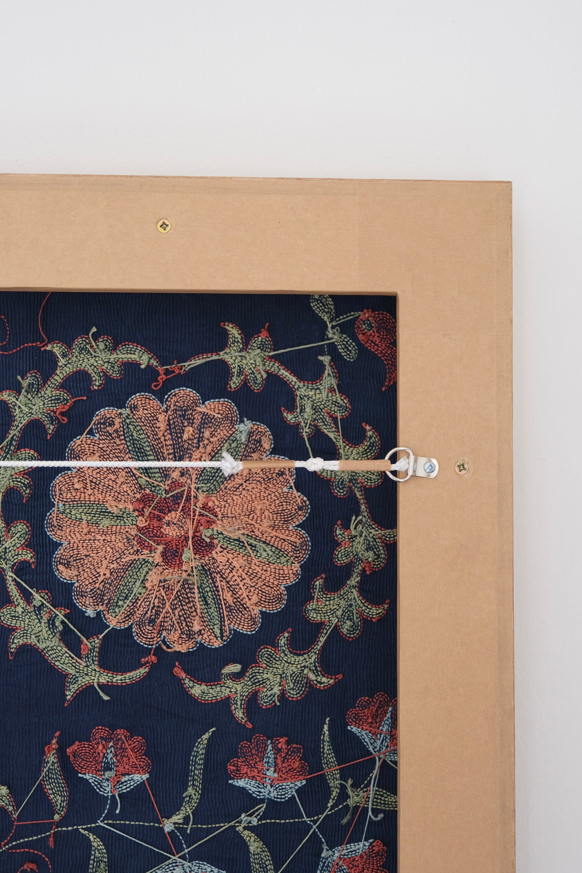 Framed suzani, embroidered textile art, wooden frame, navy blue with floral motifs, backside