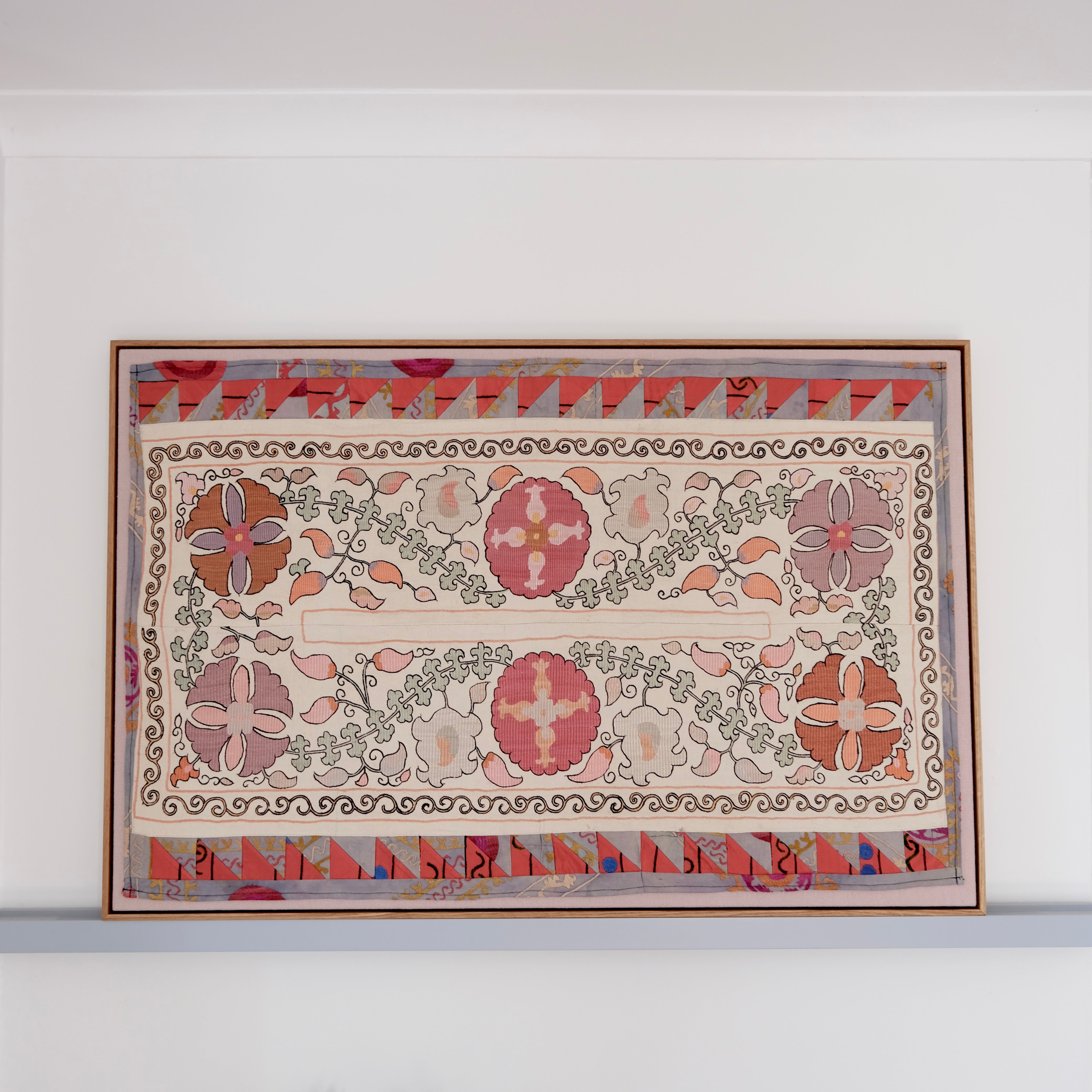 Large framed antique suzani, pastel colours