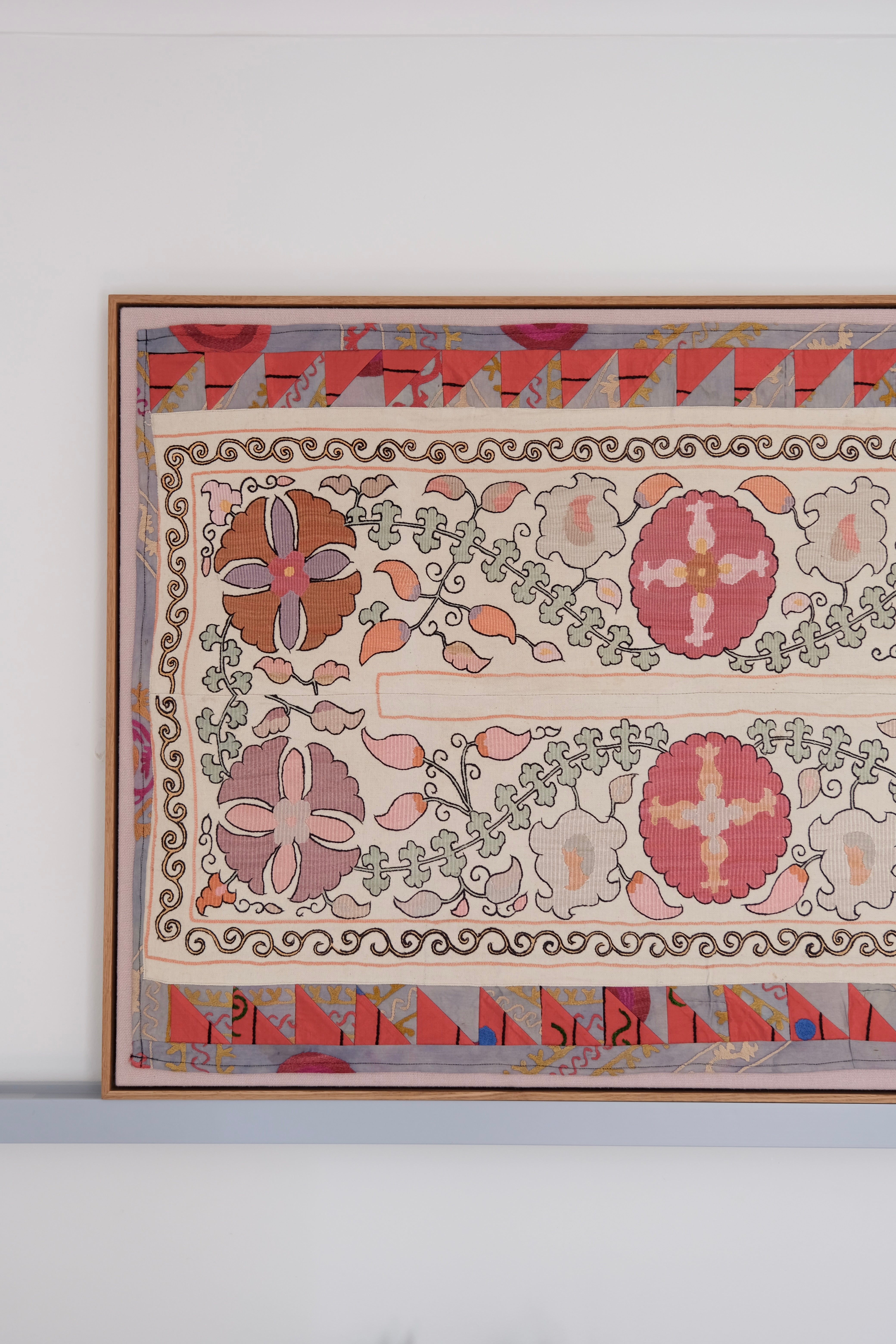 Large framed antique suzani, pastel colours