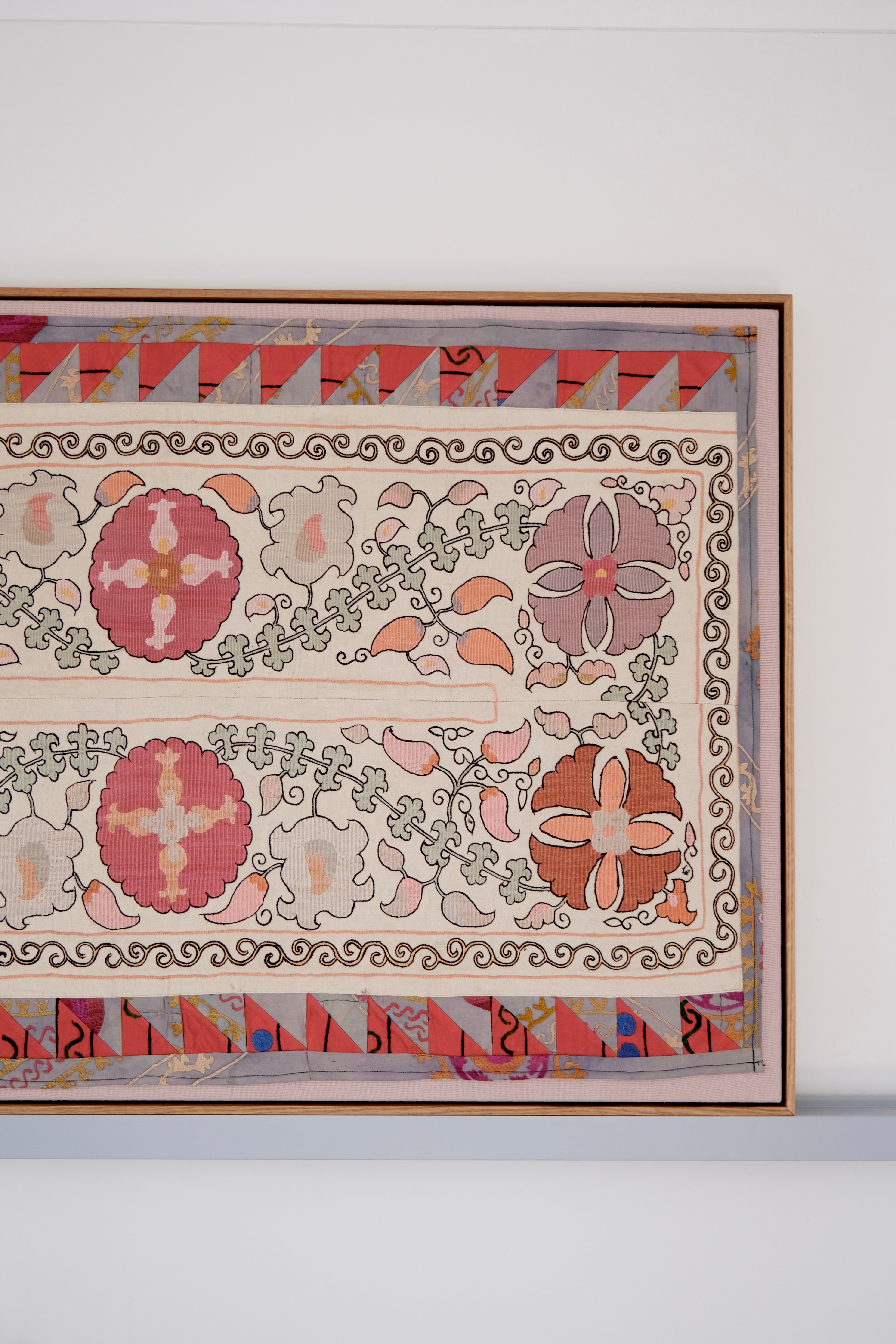 Large framed antique suzani, pastel colours