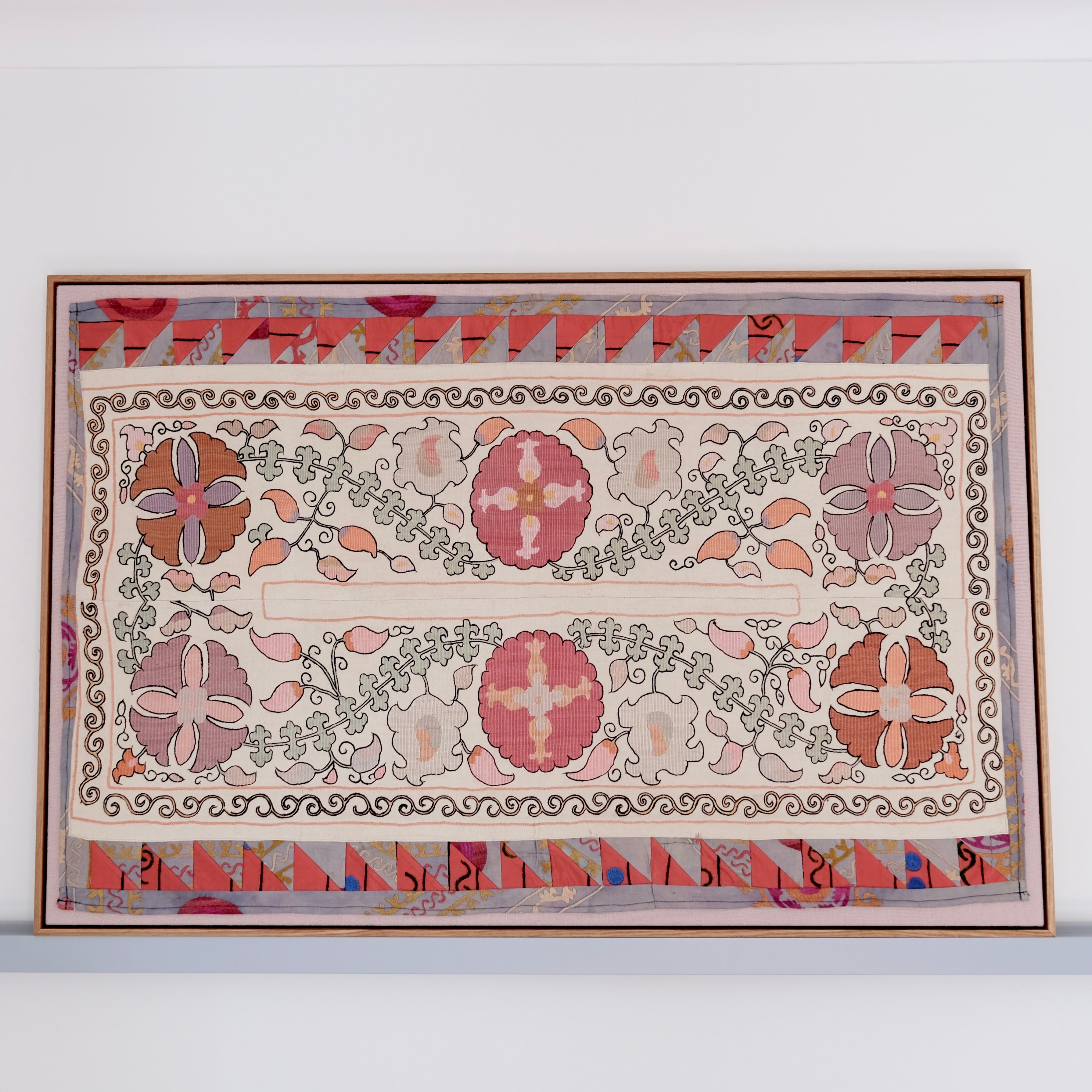 Large framed antique suzani, pastel colours