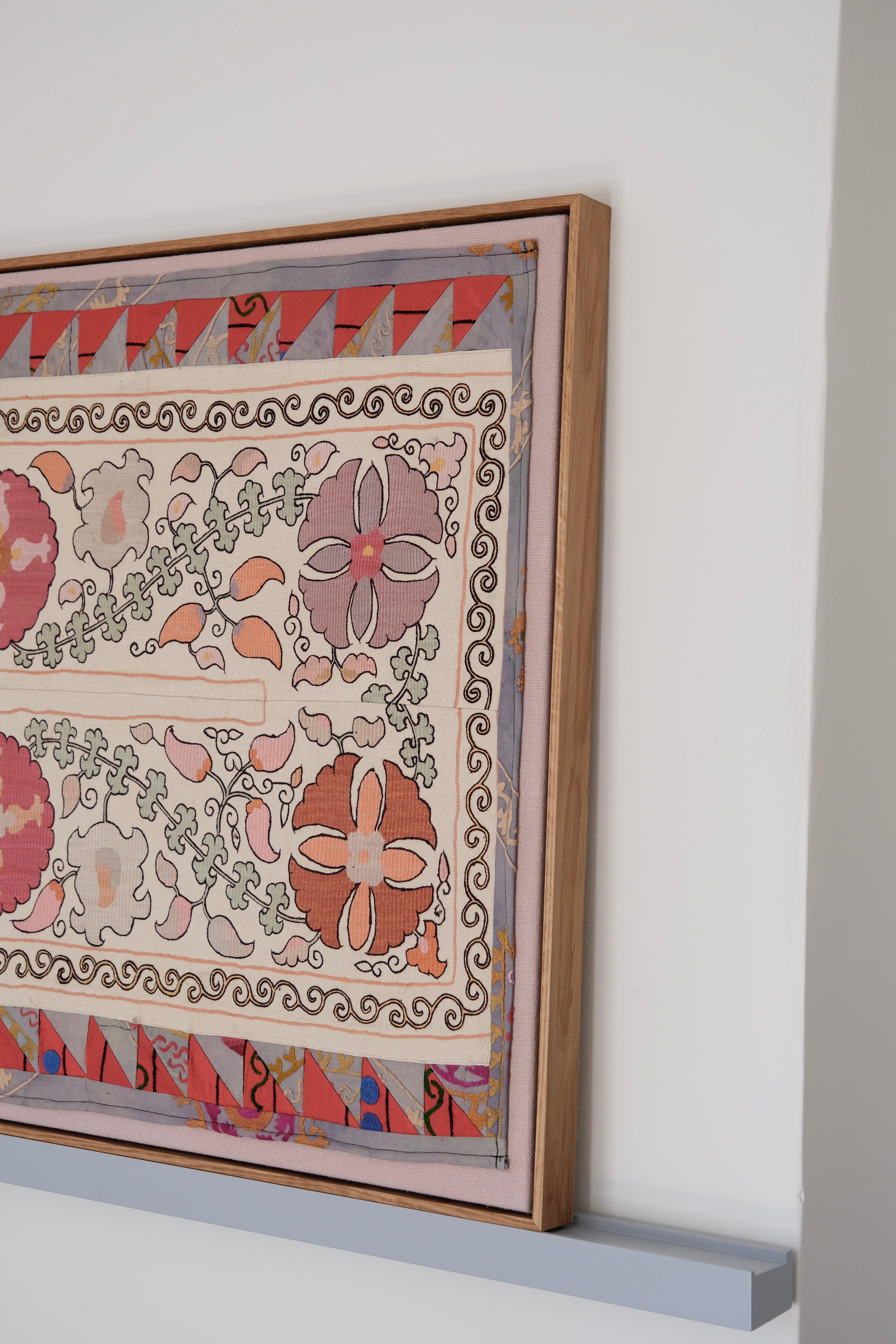 Large framed antique suzani, pastel colours