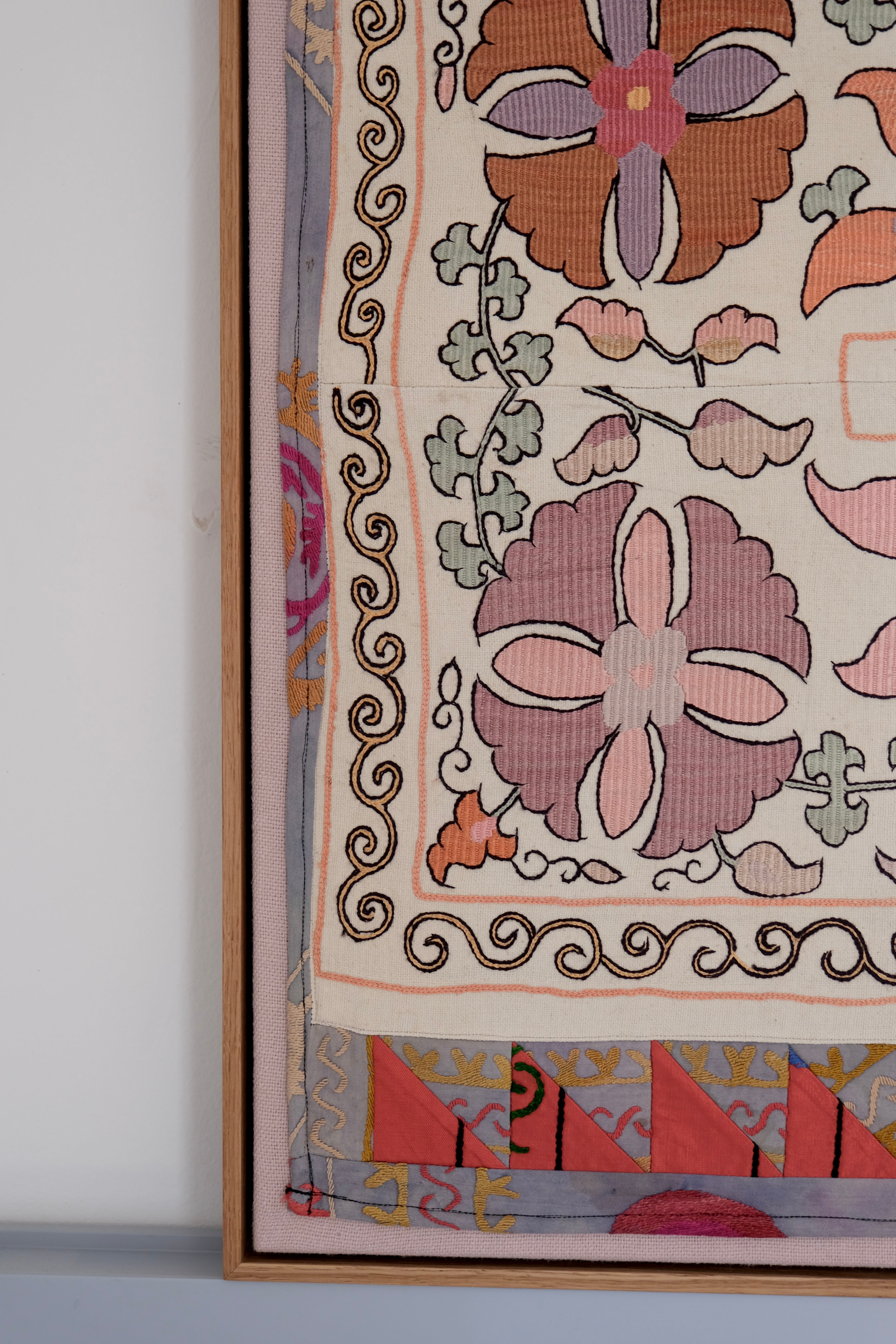 Large framed antique suzani, pastel colours