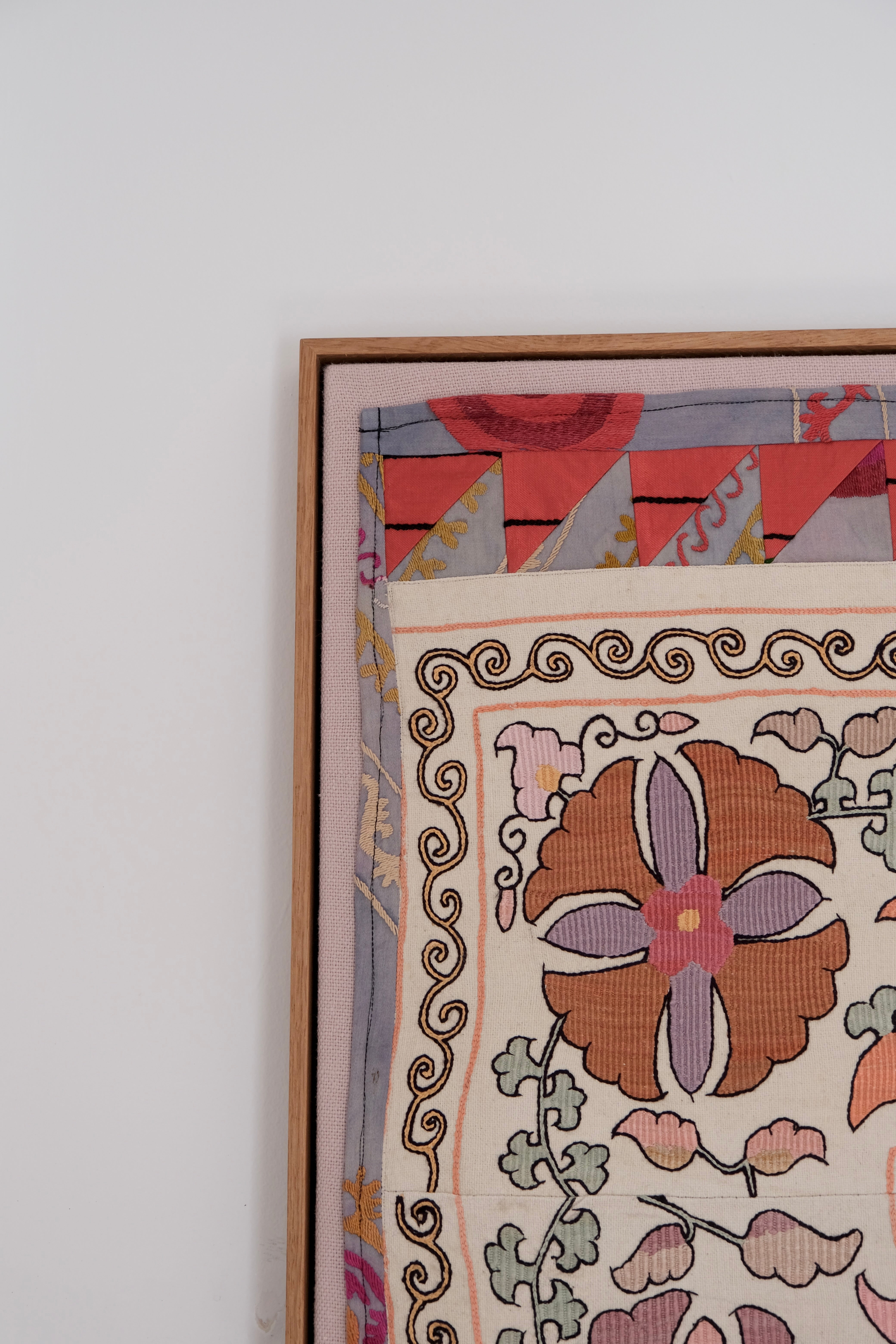 Large framed antique suzani, pastel colours