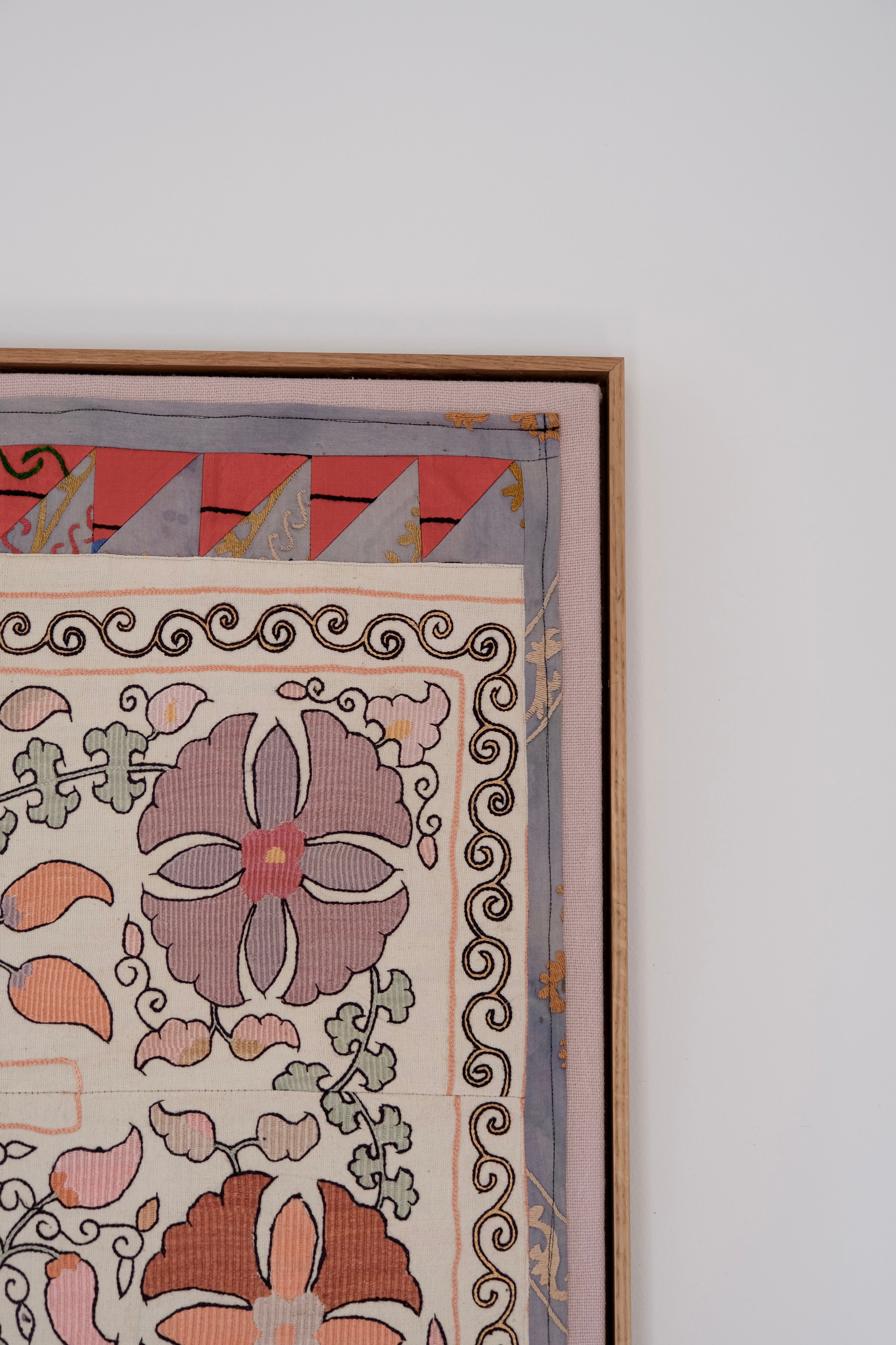 Large framed antique suzani, pastel colours