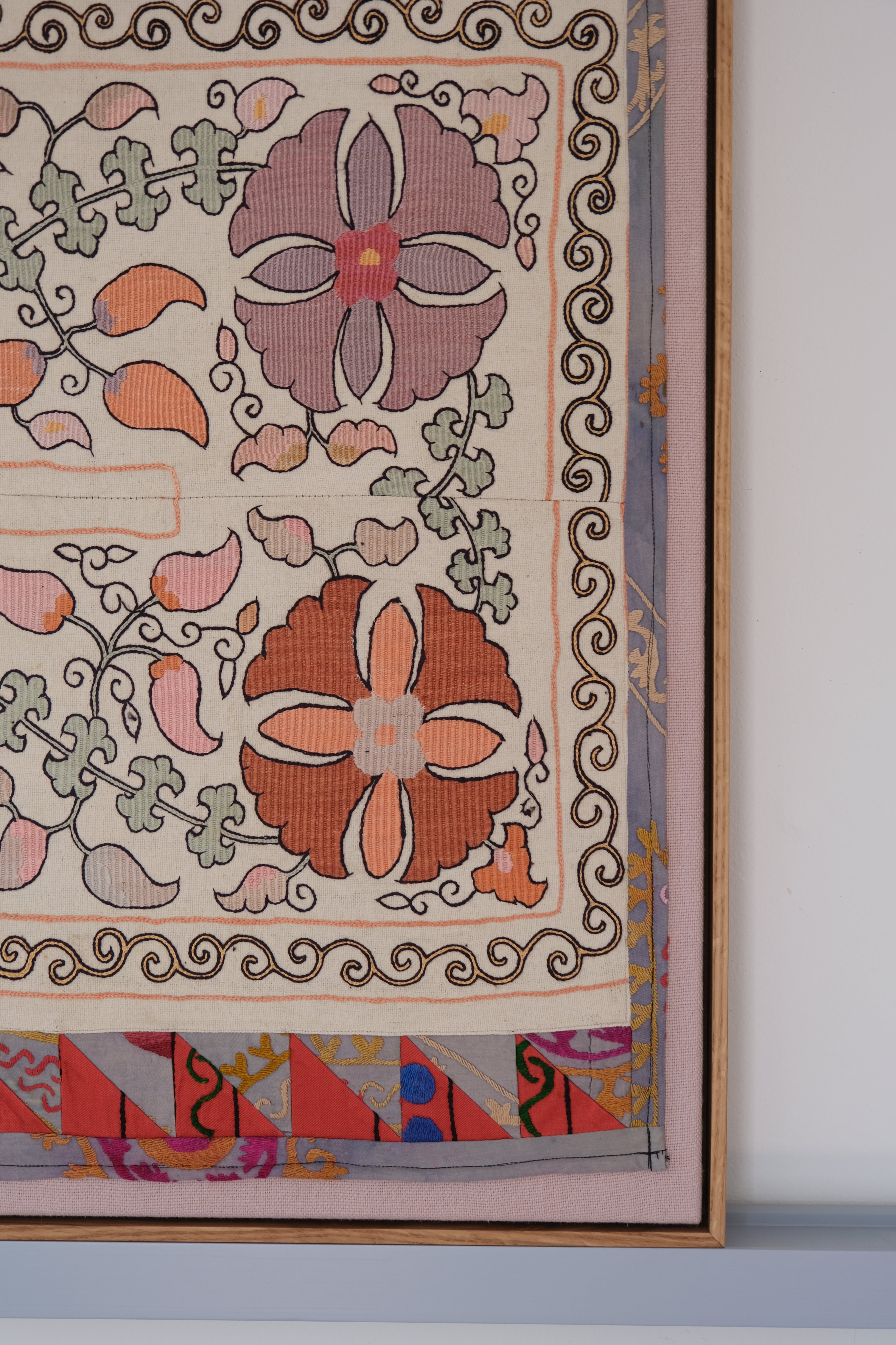 Large framed antique suzani, pastel colours