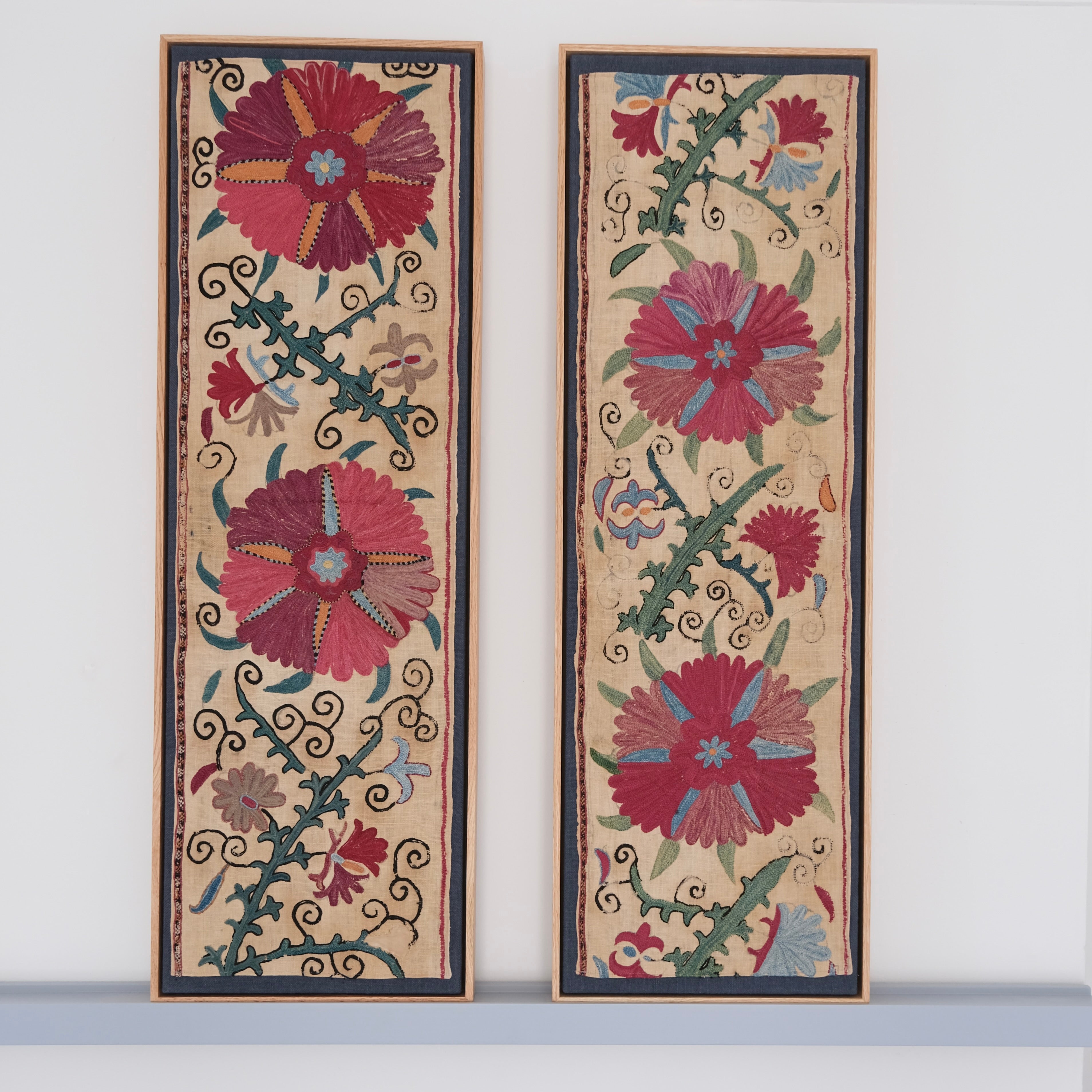 Pair of framed antique suzanis, pink & tan