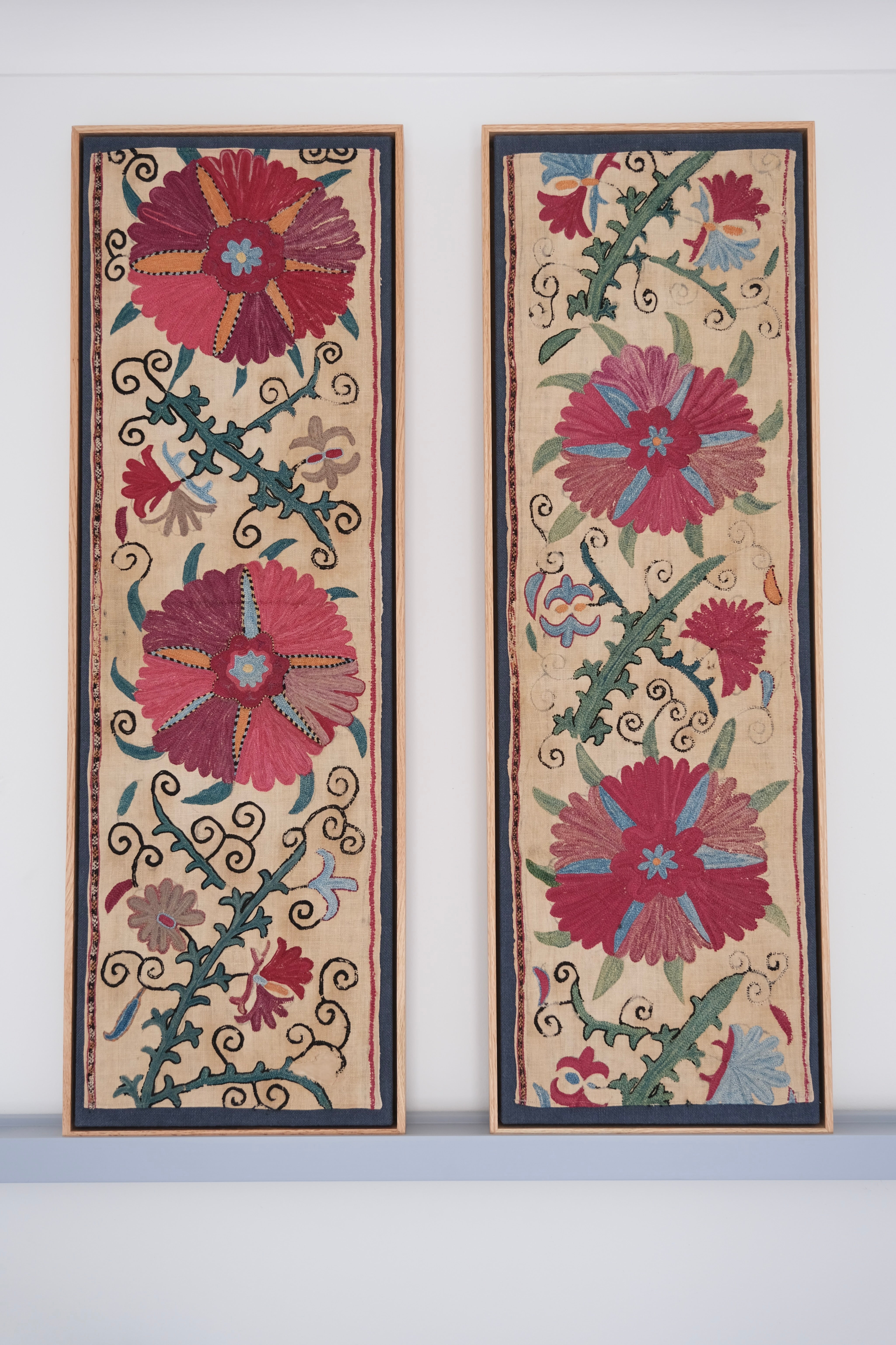 Pair of framed antique suzanis, pink & tan