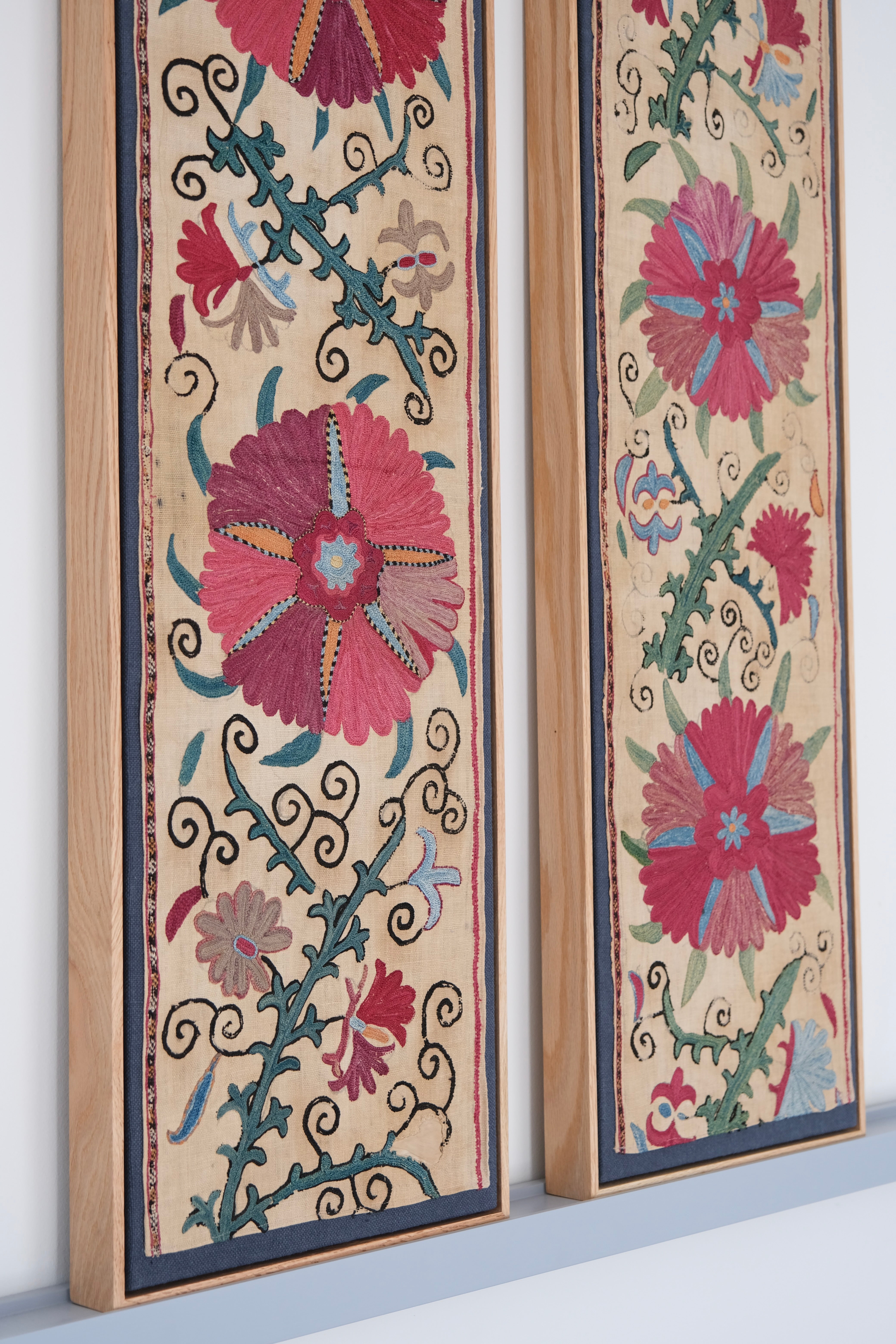 Pair of framed antique suzanis, pink & tan