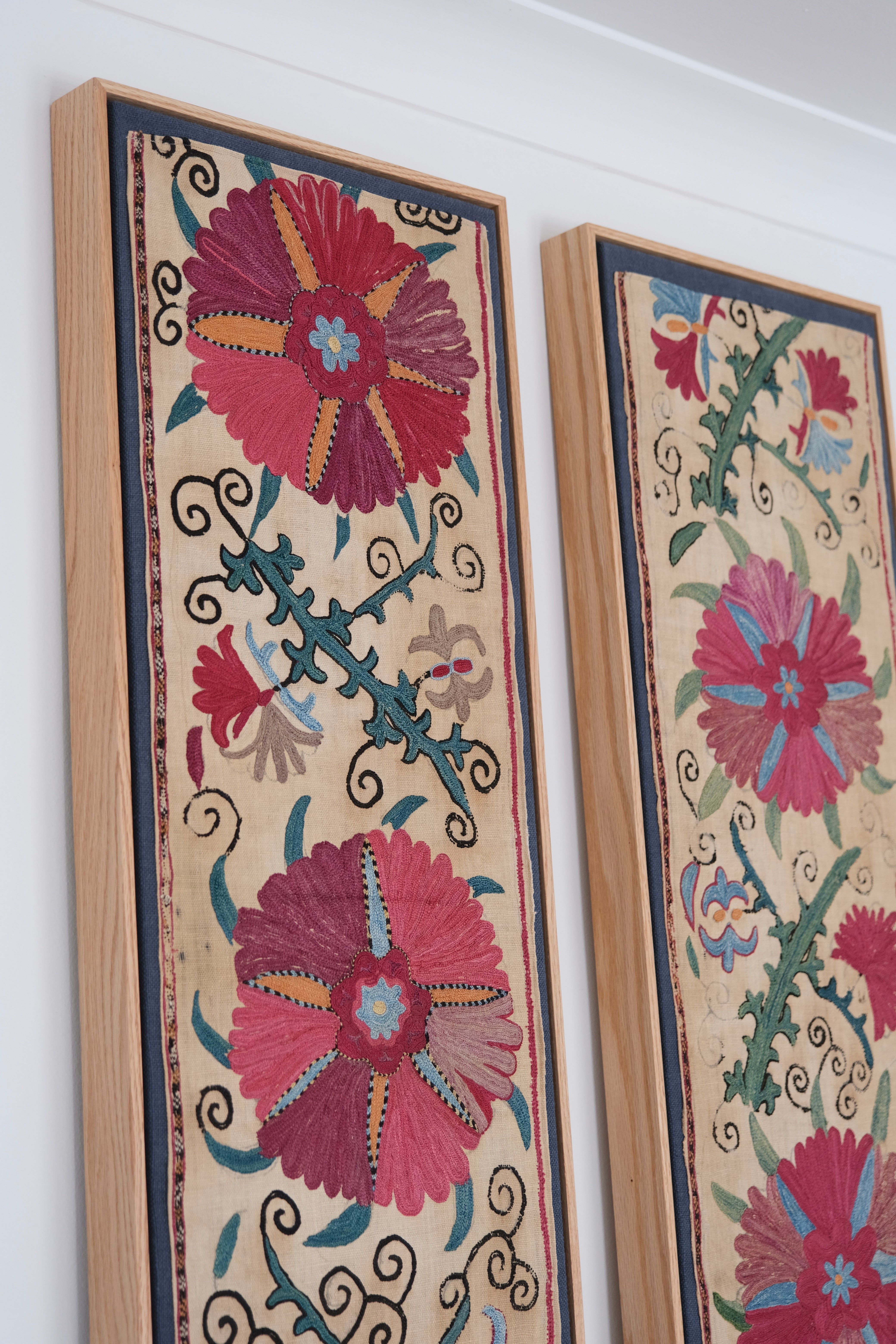 Pair of framed antique suzanis, pink & tan