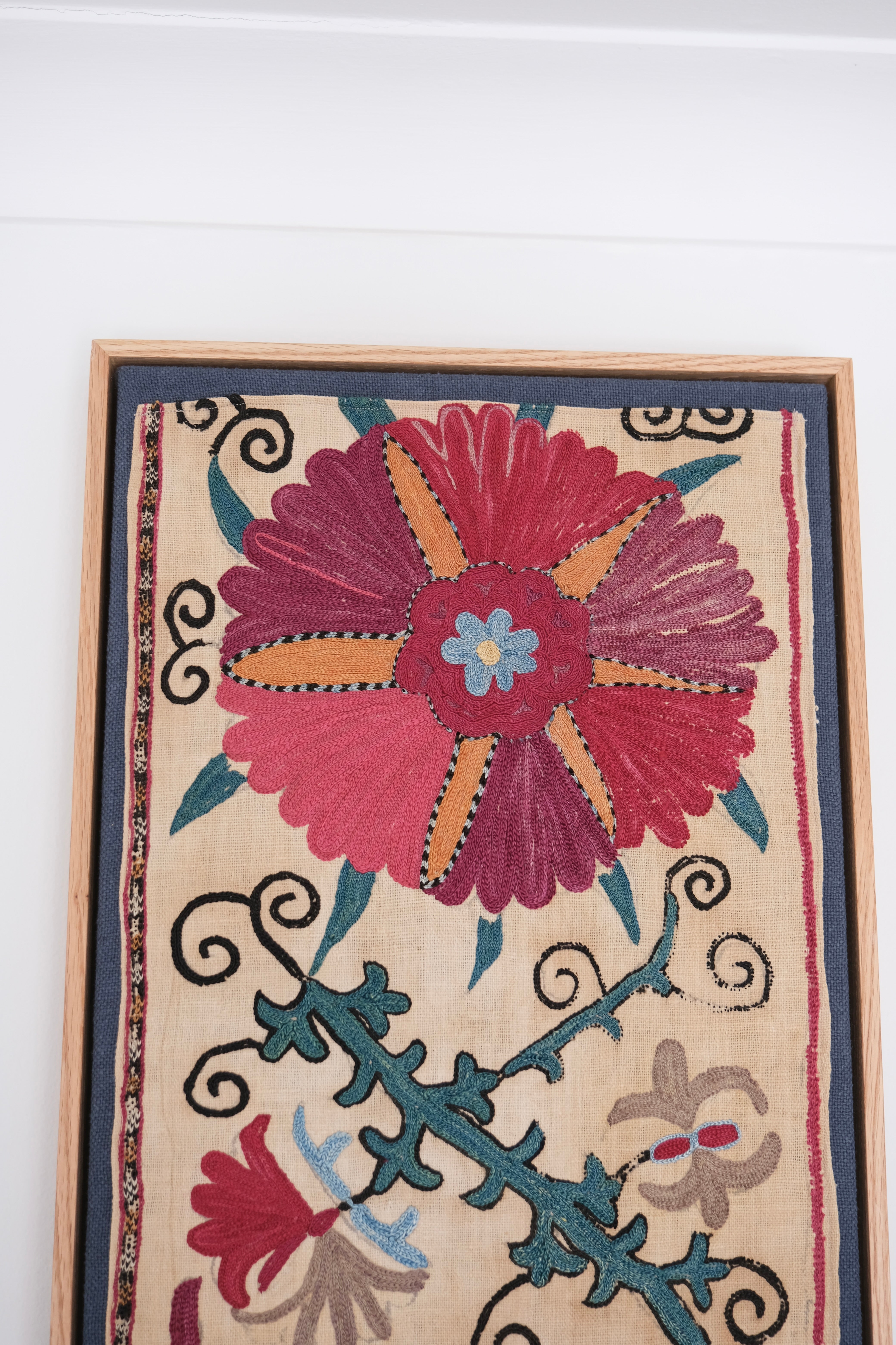 Pair of framed antique suzanis, pink & tan