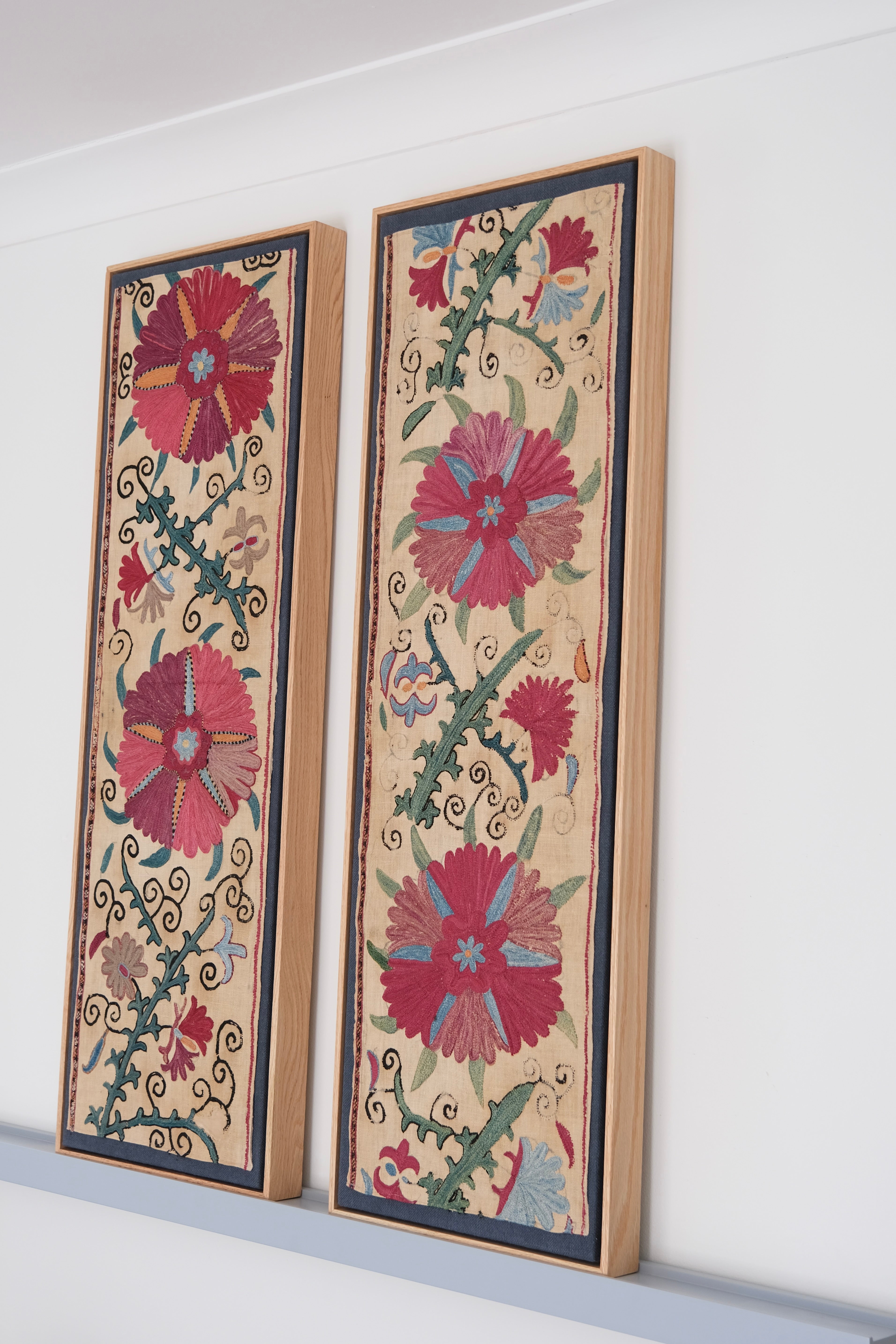 Pair of framed antique suzanis, pink & tan