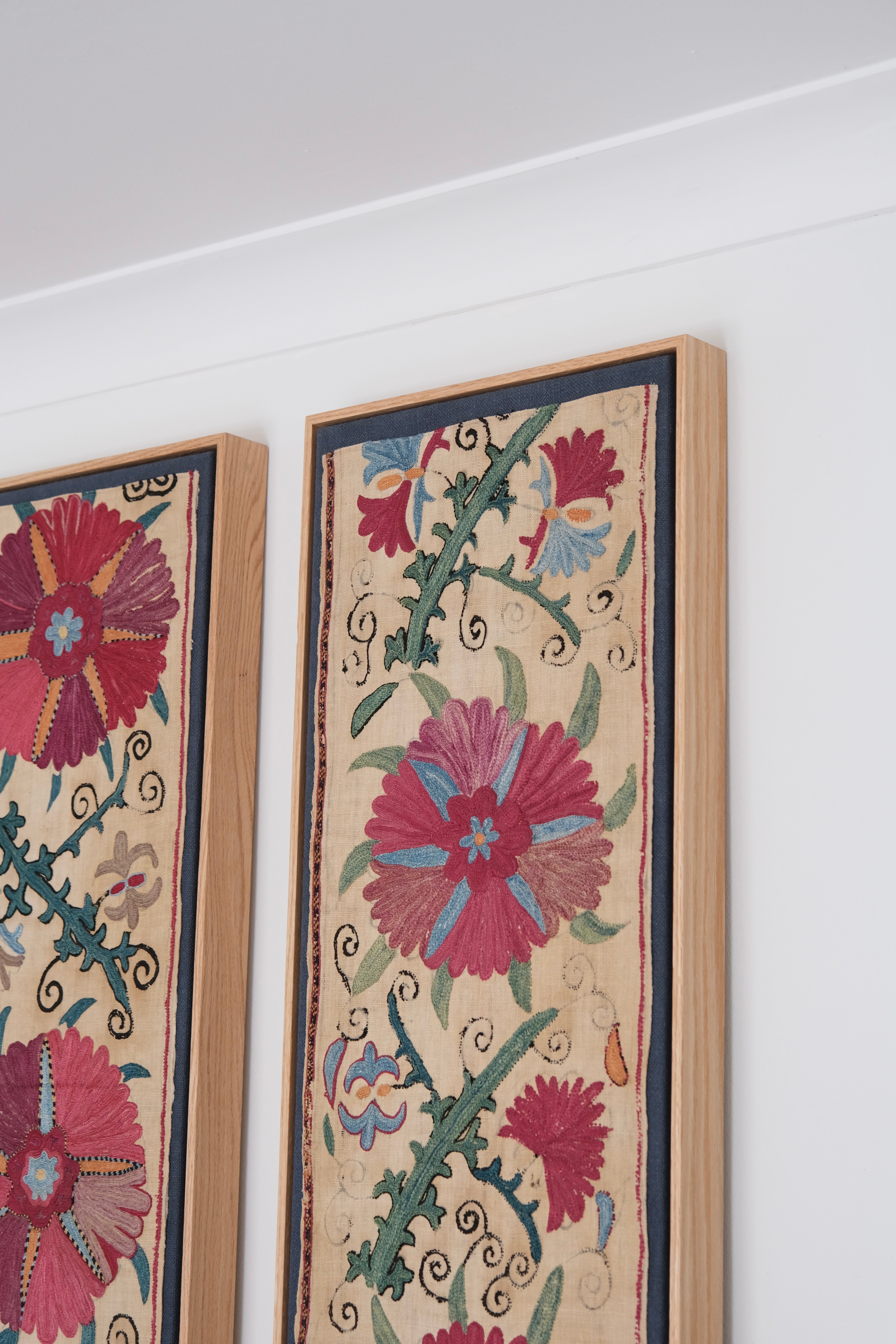 Pair of framed antique suzanis, pink & tan