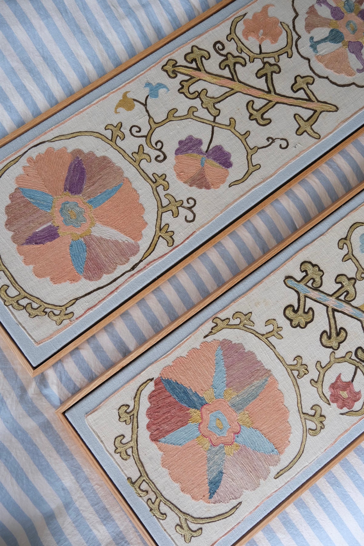 Pair of framed antique suzanis, pastel colours