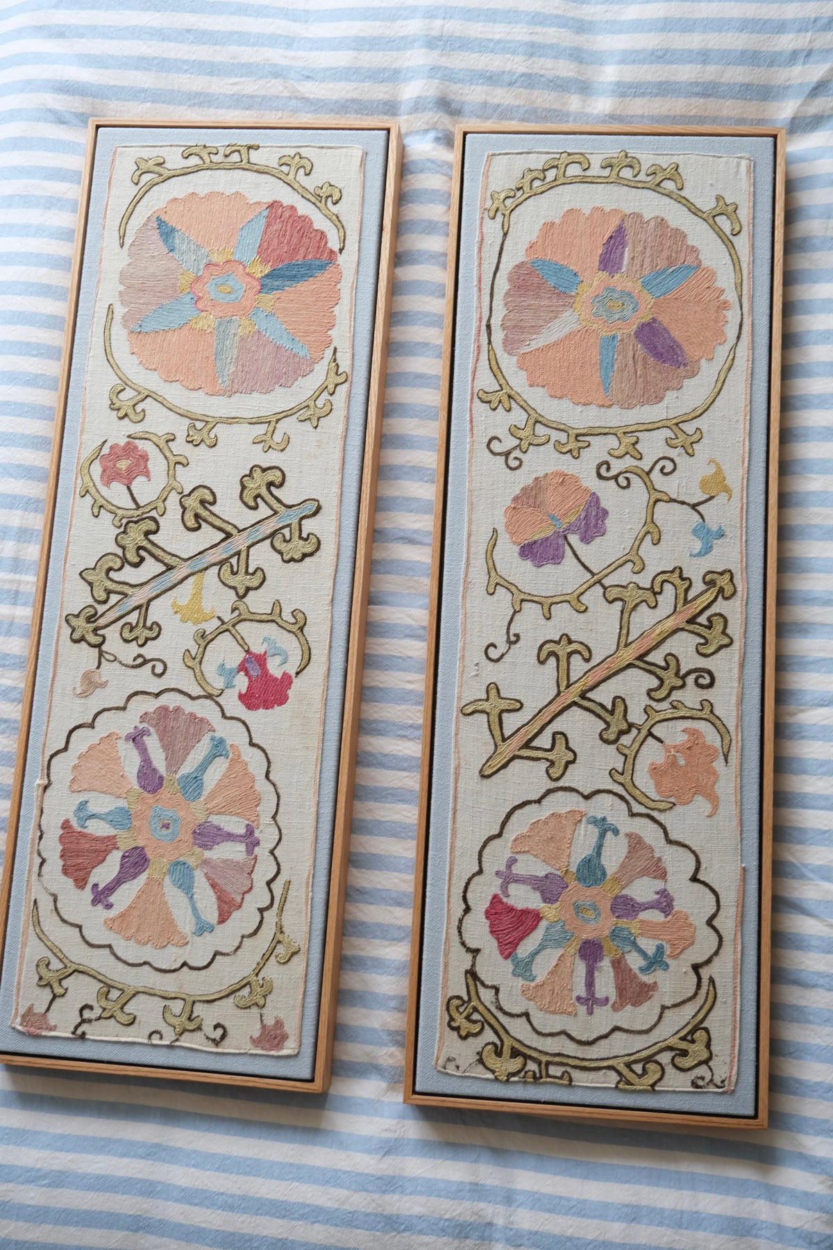 Pair of framed antique suzanis, pastel colours