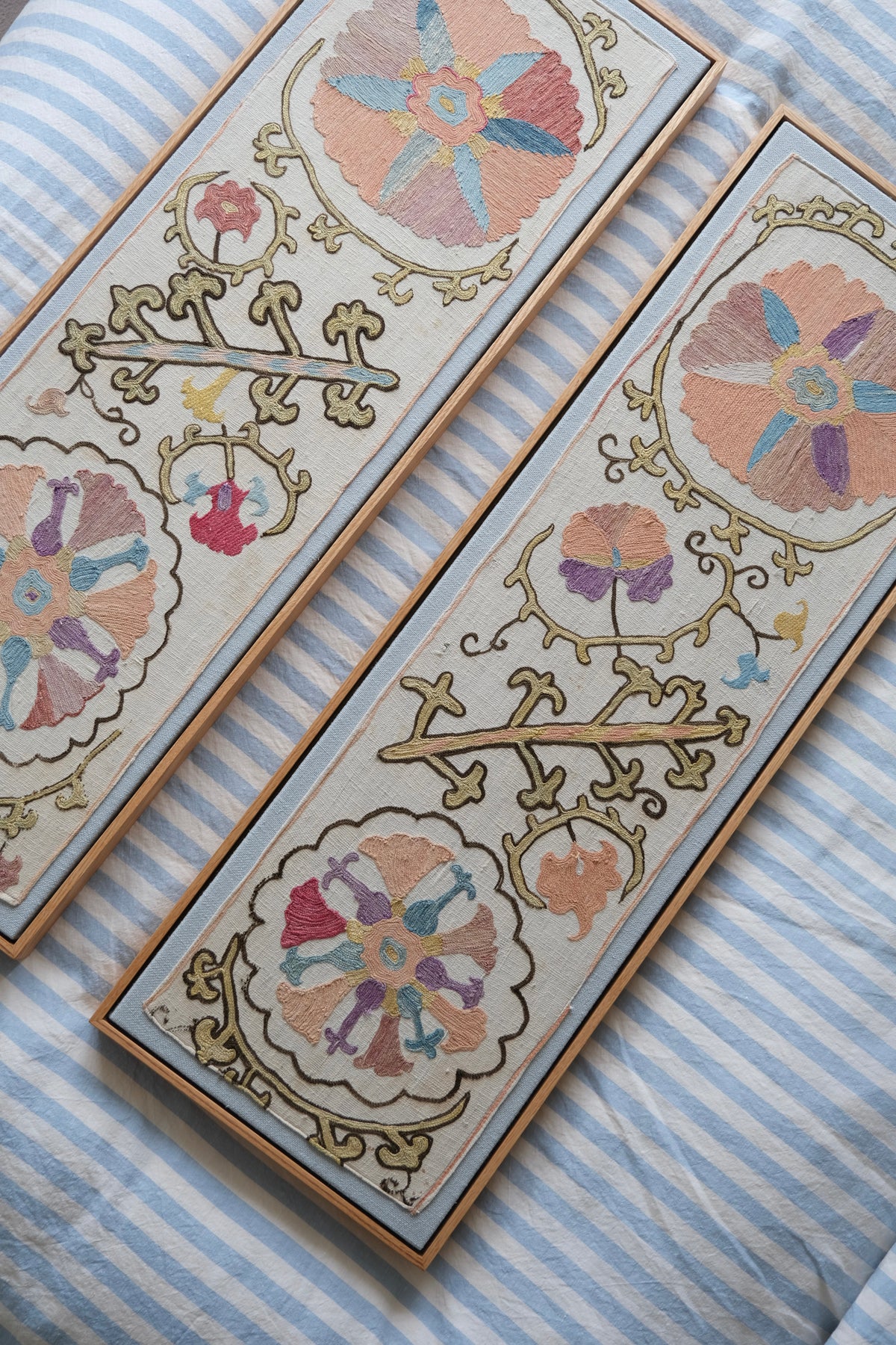Pair of framed antique suzanis, pastel colours