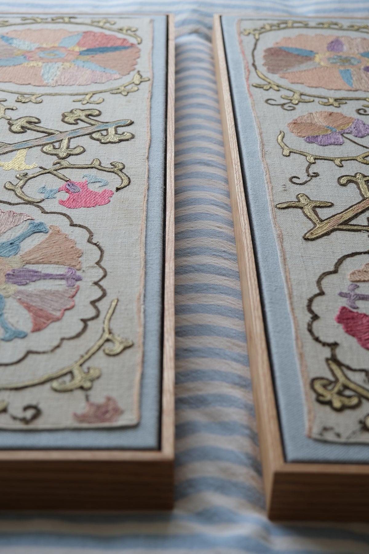 Pair of framed antique suzanis, pastel colours