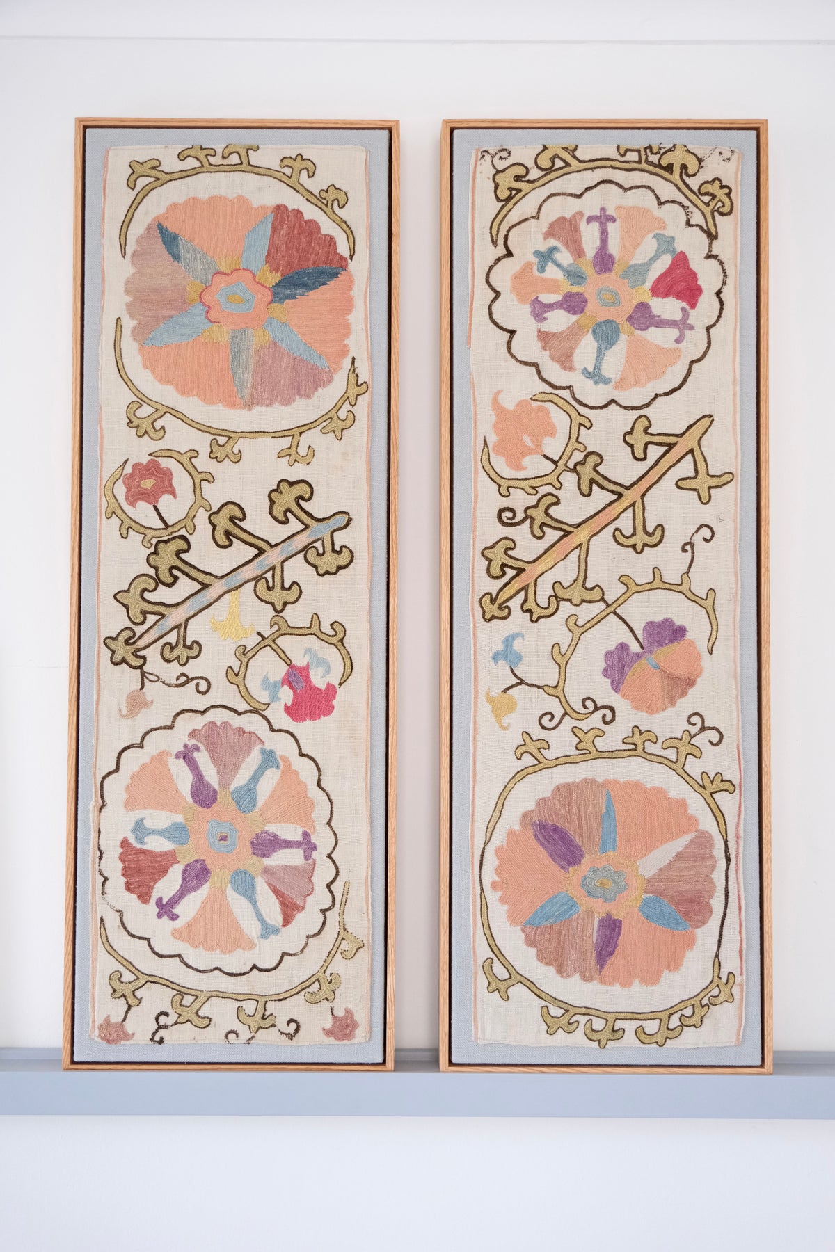 Pair of framed antique suzanis, pastel colours