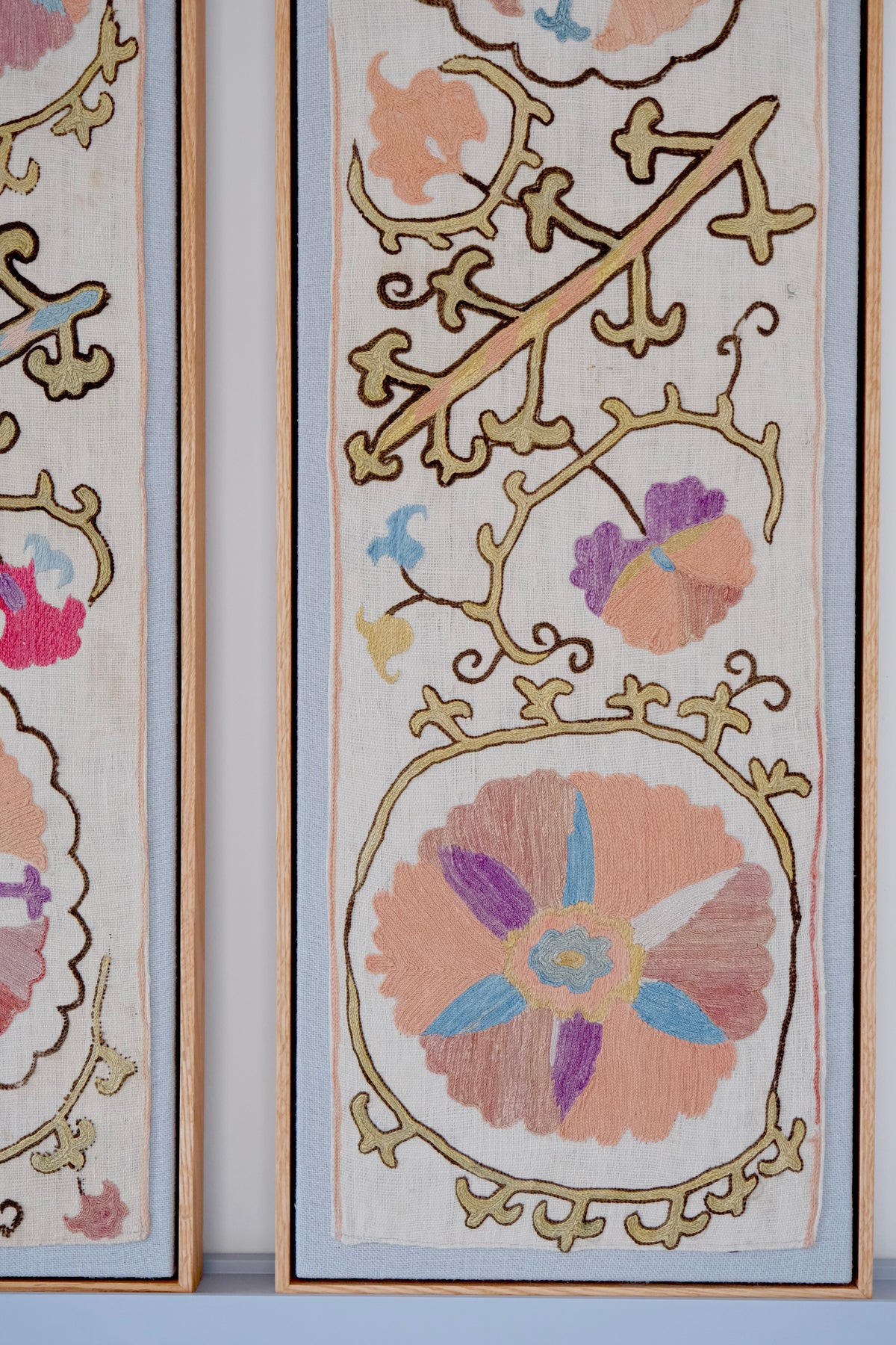 Pair of framed antique suzanis, pastel colours