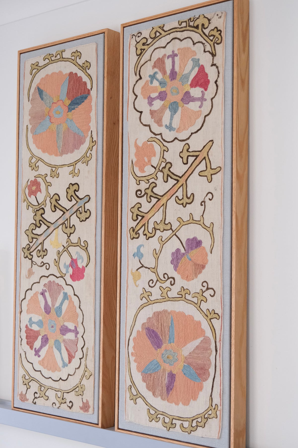 Pair of framed antique suzanis, pastel colours