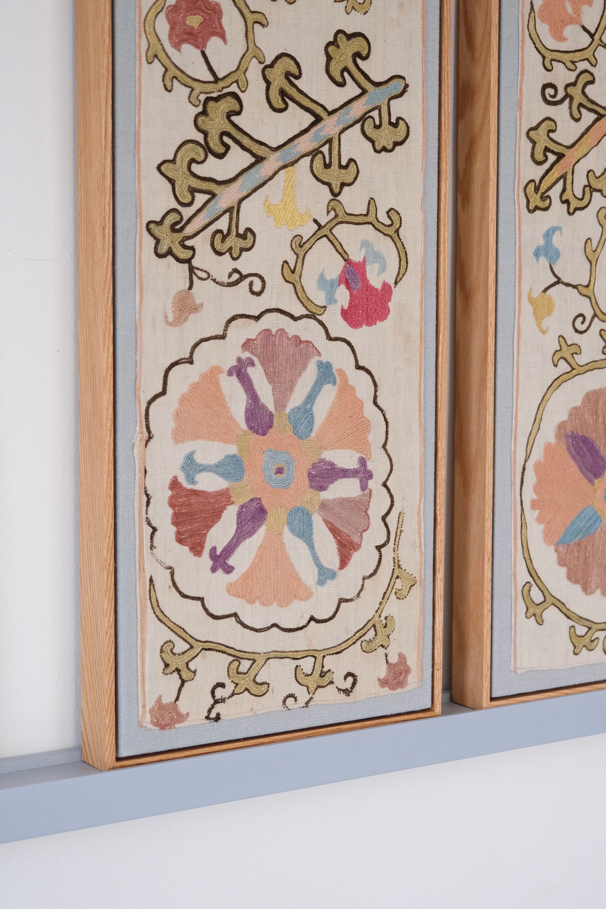 Pair of framed antique suzanis, pastel colours