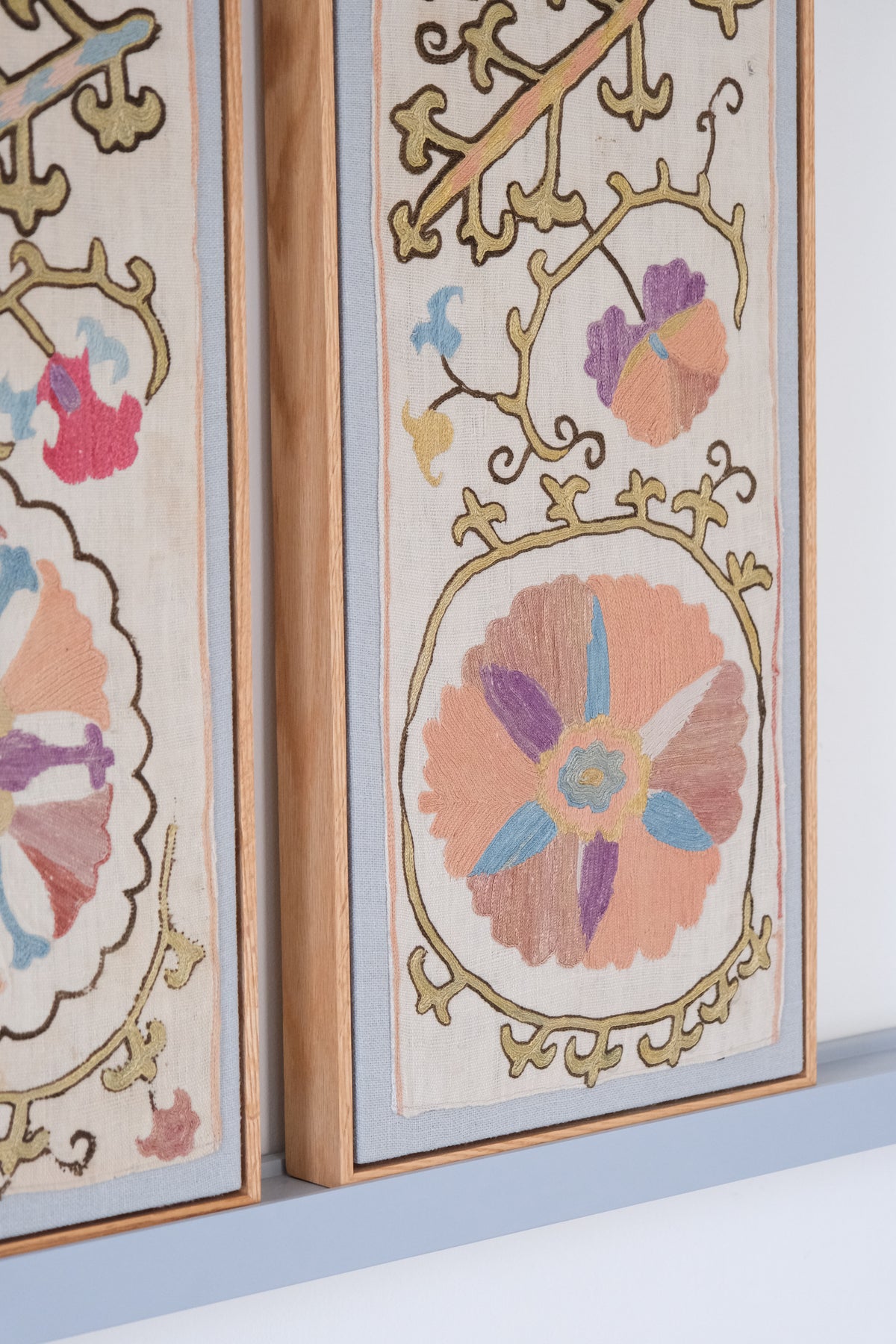Pair of framed antique suzanis, pastel colours