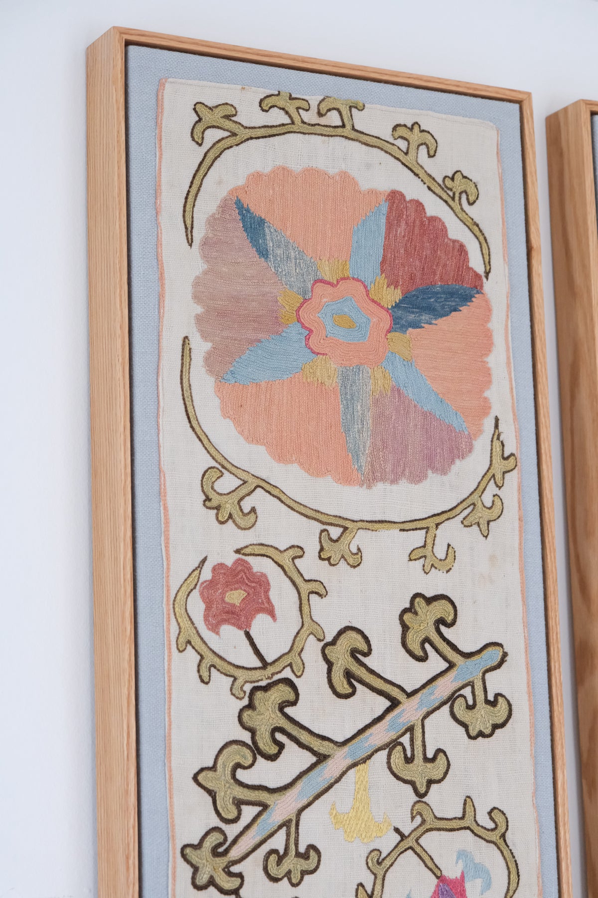 Pair of framed antique suzanis, pastel colours