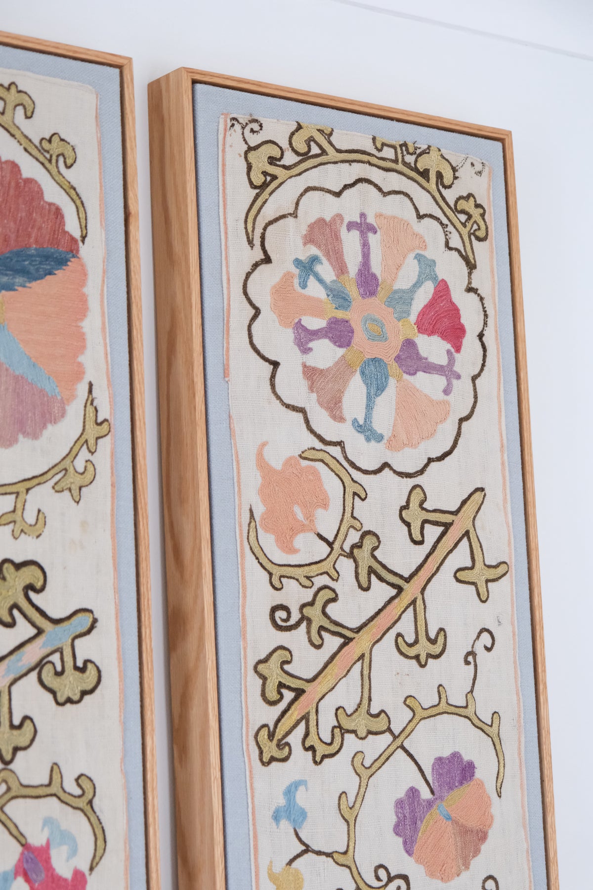 Pair of framed antique suzanis, pastel colours