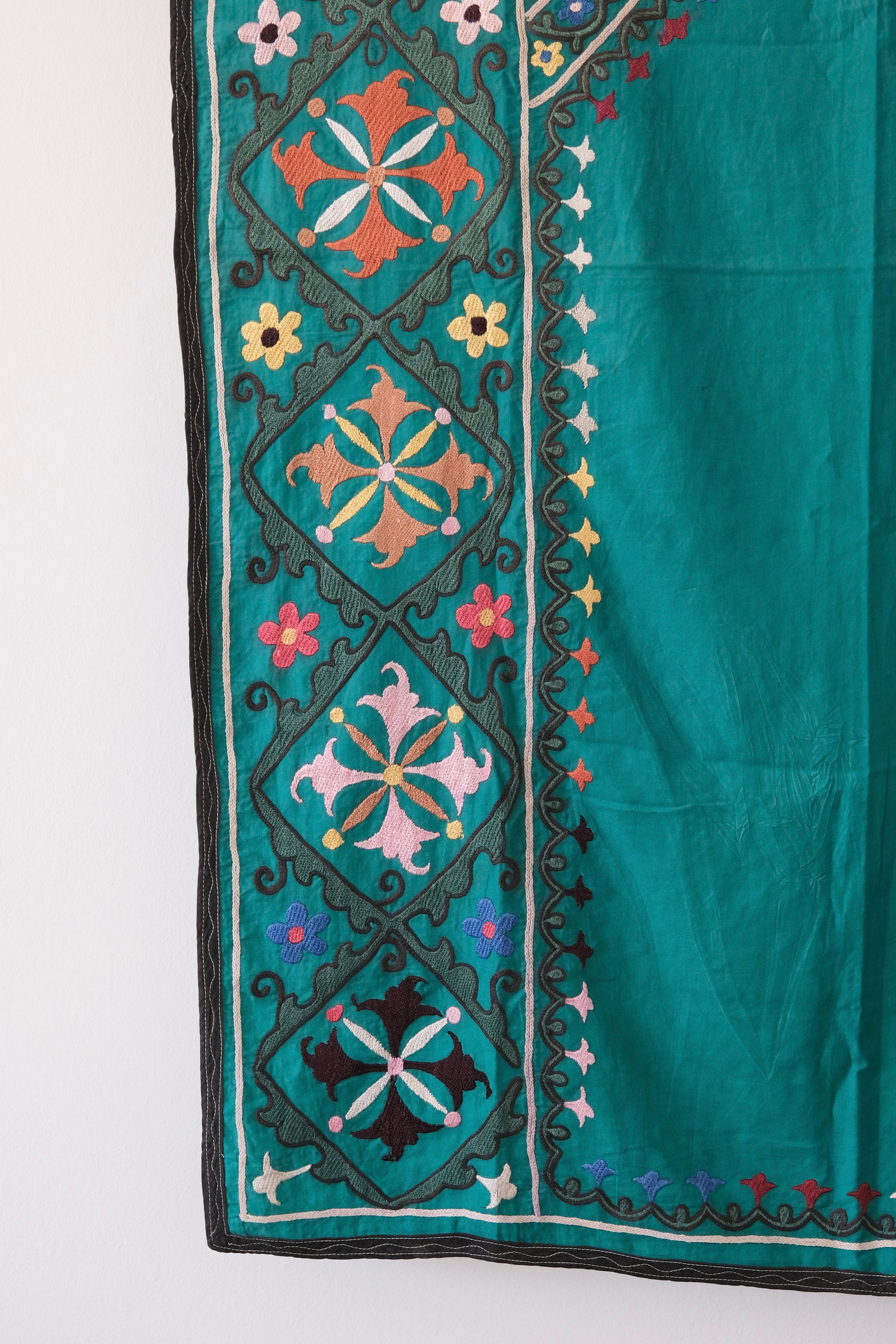 Vintage suzani, colourful embroidered textile, turquoise with flowers