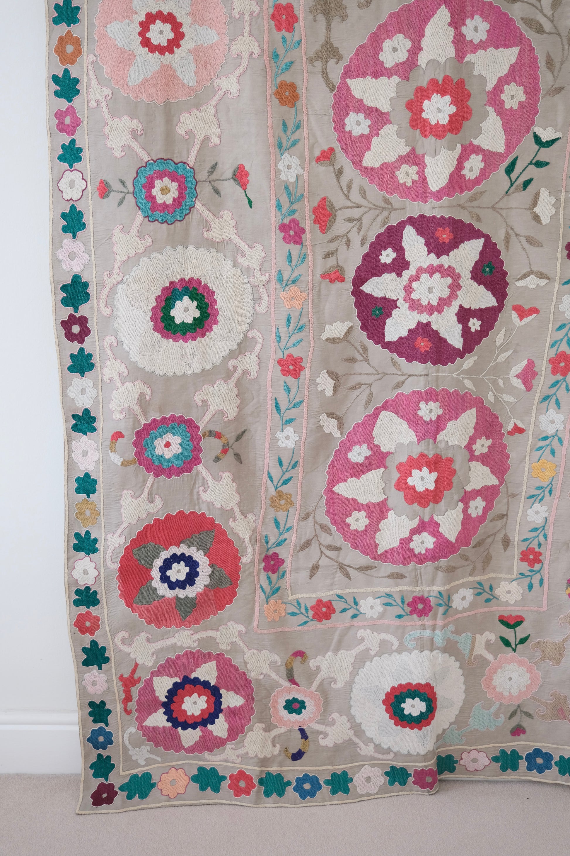 Vintage suzani, colourful bedspread, embroidered textile, close-up