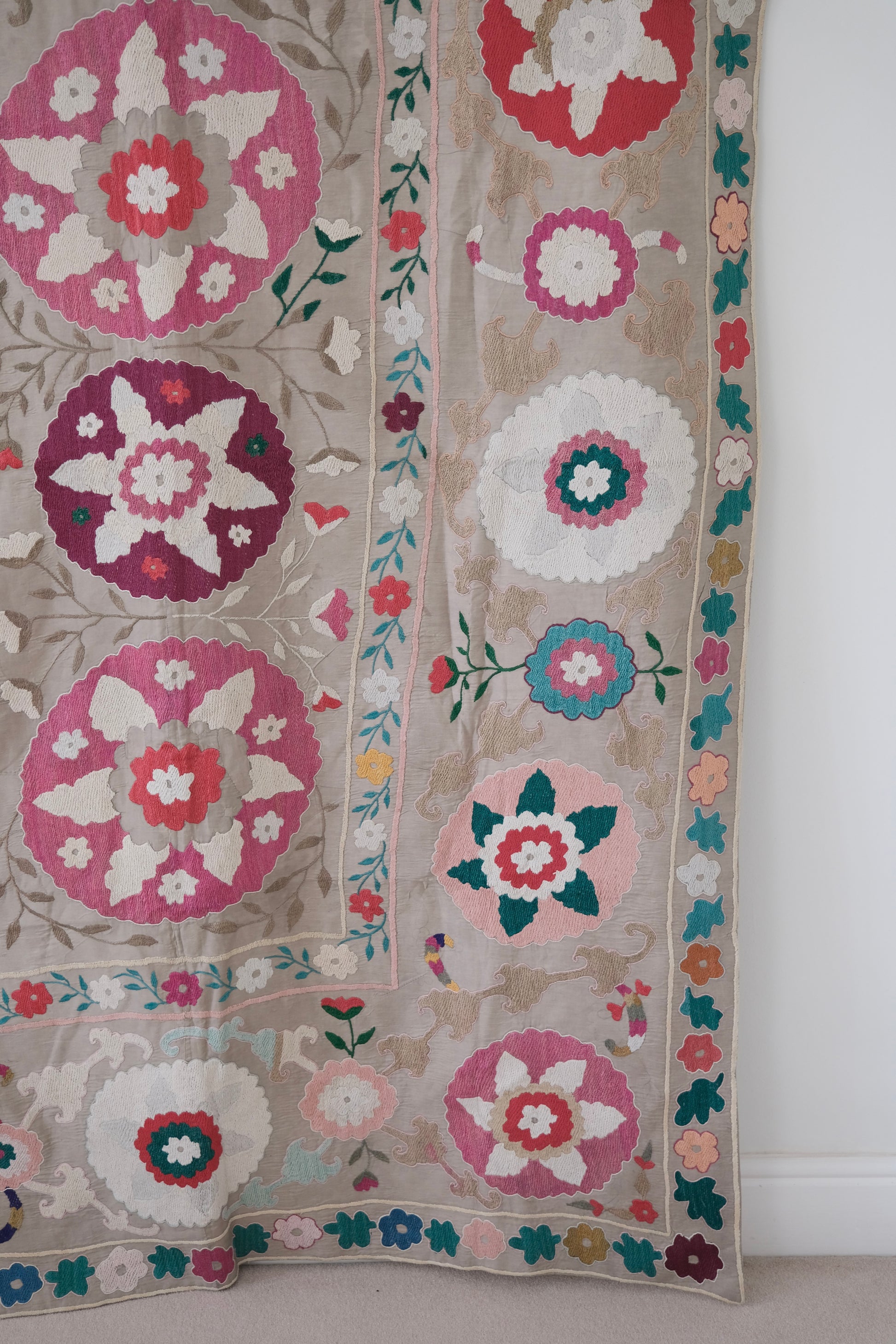 Vintage suzani, colourful bedspread, embroidered textile, close-up