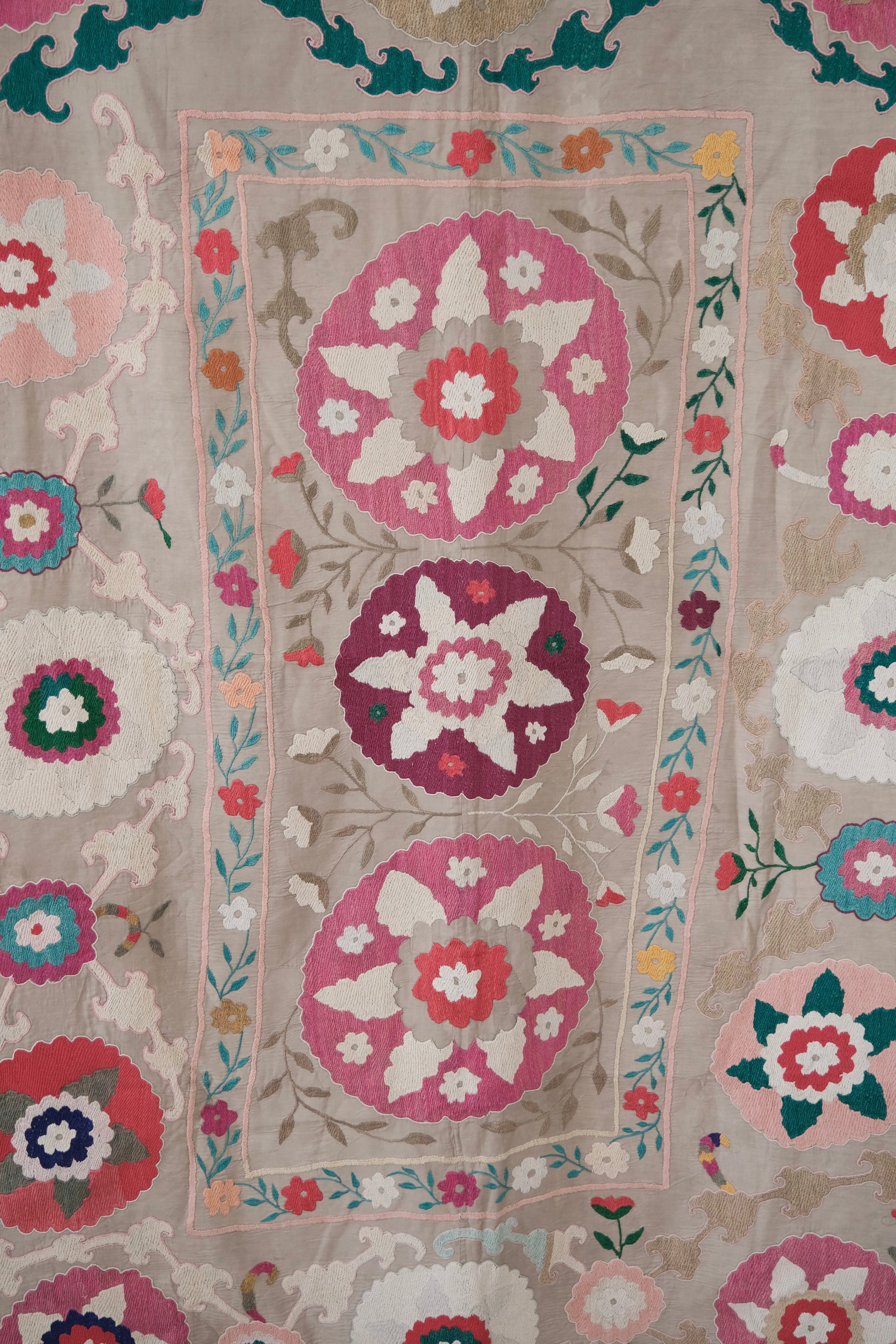 Vintage suzani, colourful bedspread, embroidered textile, close-up