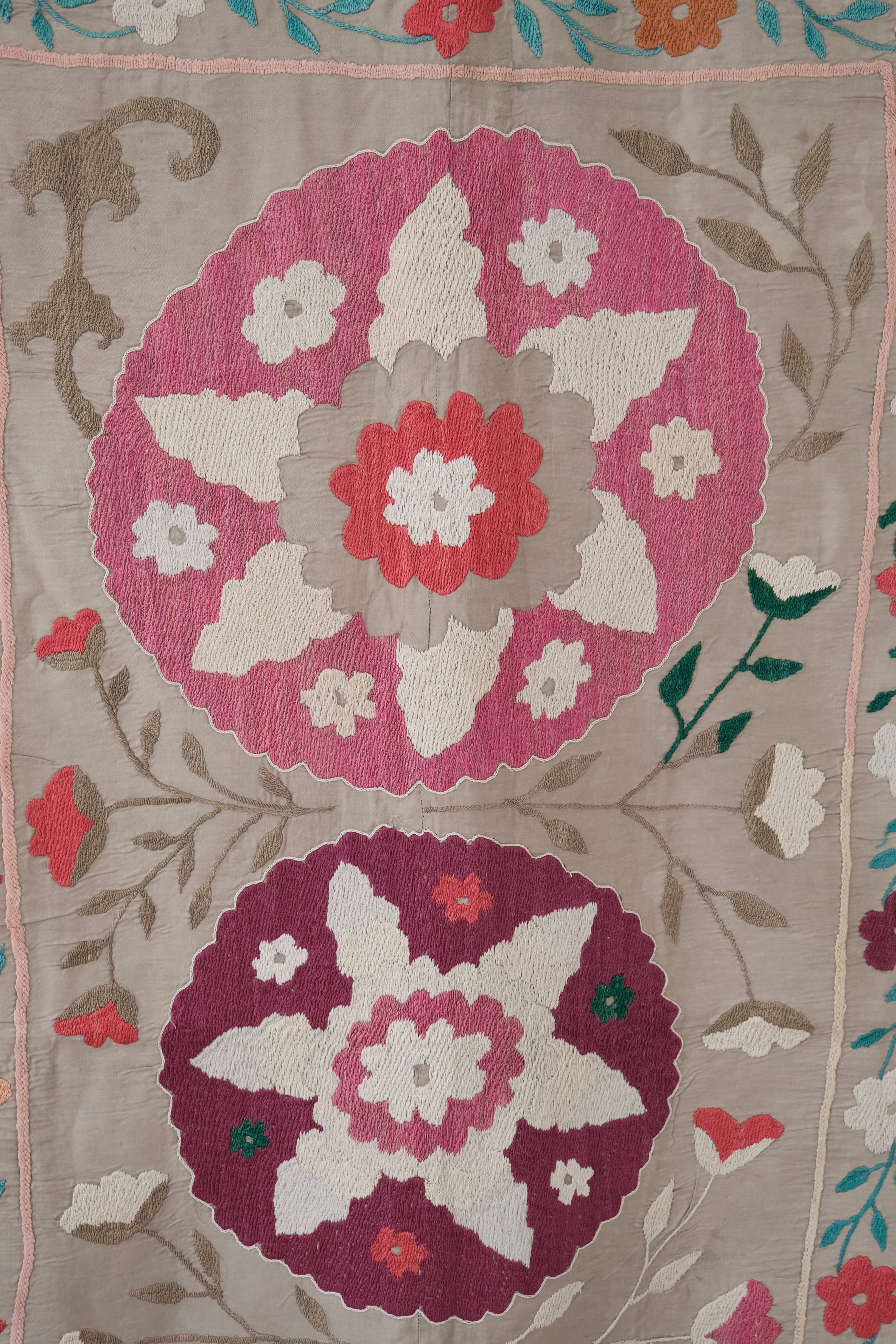 Vintage suzani, colourful bedspread, embroidered textile, close-up
