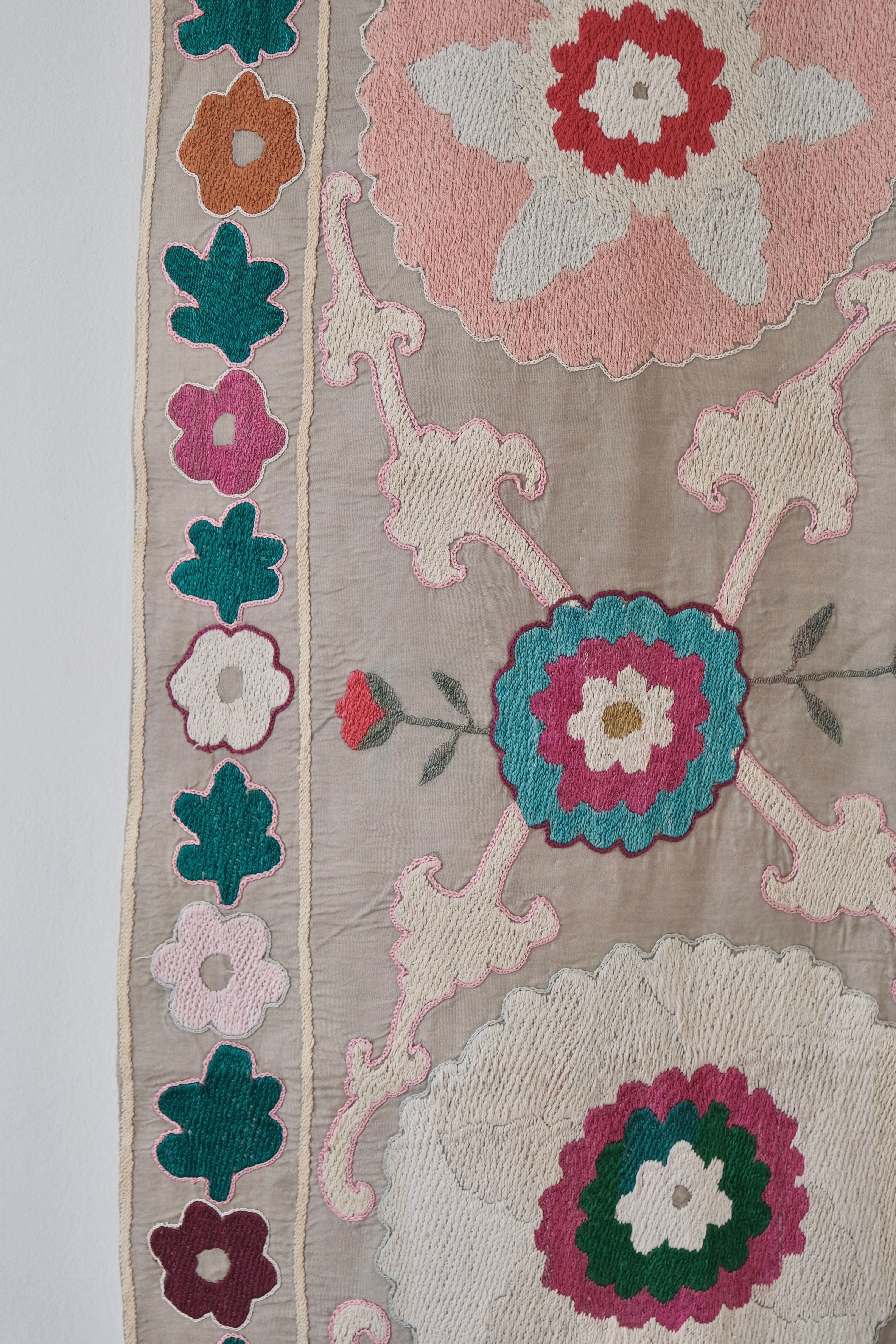 Vintage suzani, colourful bedspread, embroidered textile, close-up