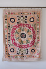 Vintage suzani, decorative embroidered tapestry, pink with geometric and floral design