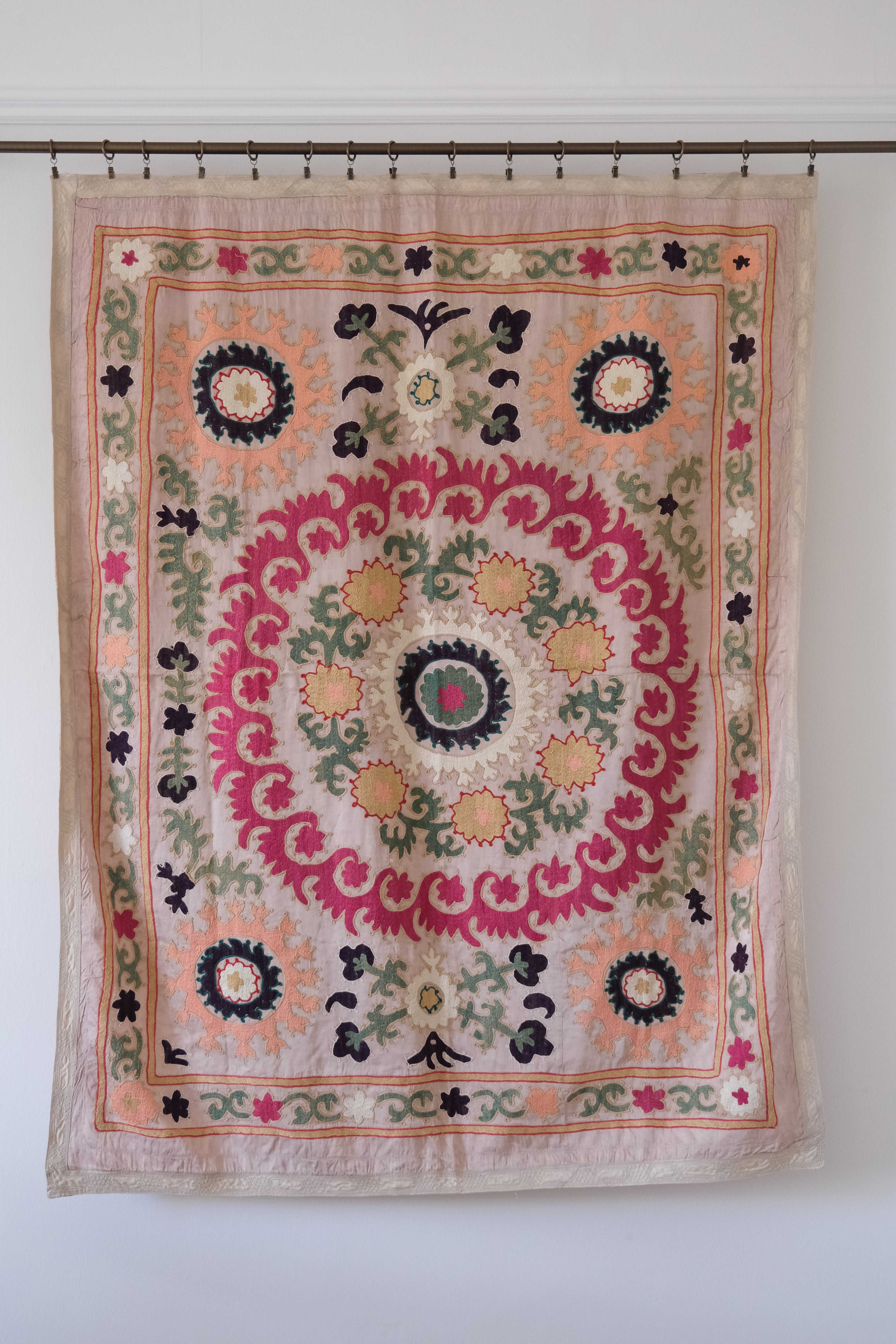 Vintage suzani, decorative embroidered tapestry, pink with geometric and floral design