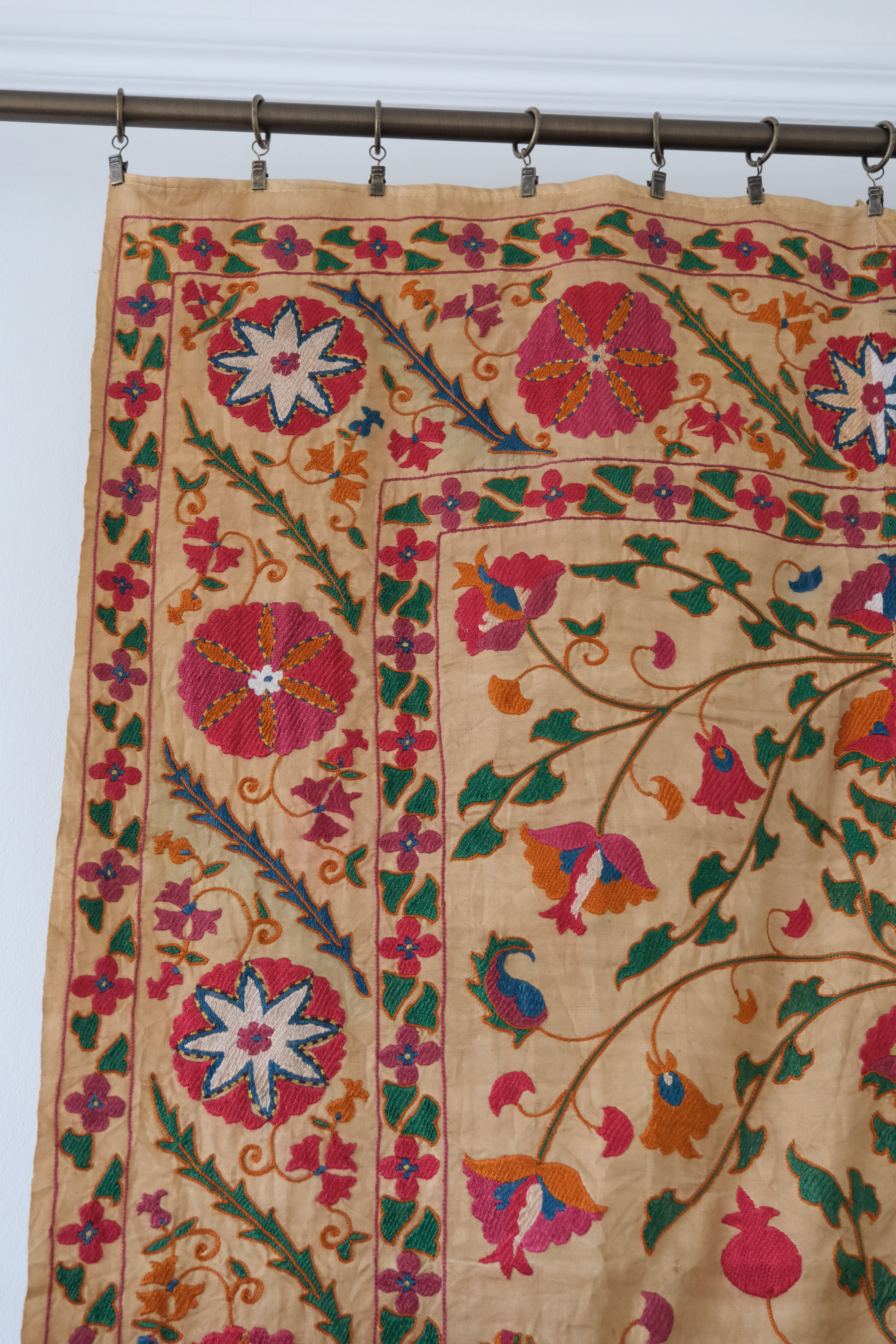 Antique suzani wallhanging, embroidered antique textile, camel with pink florals, close-up