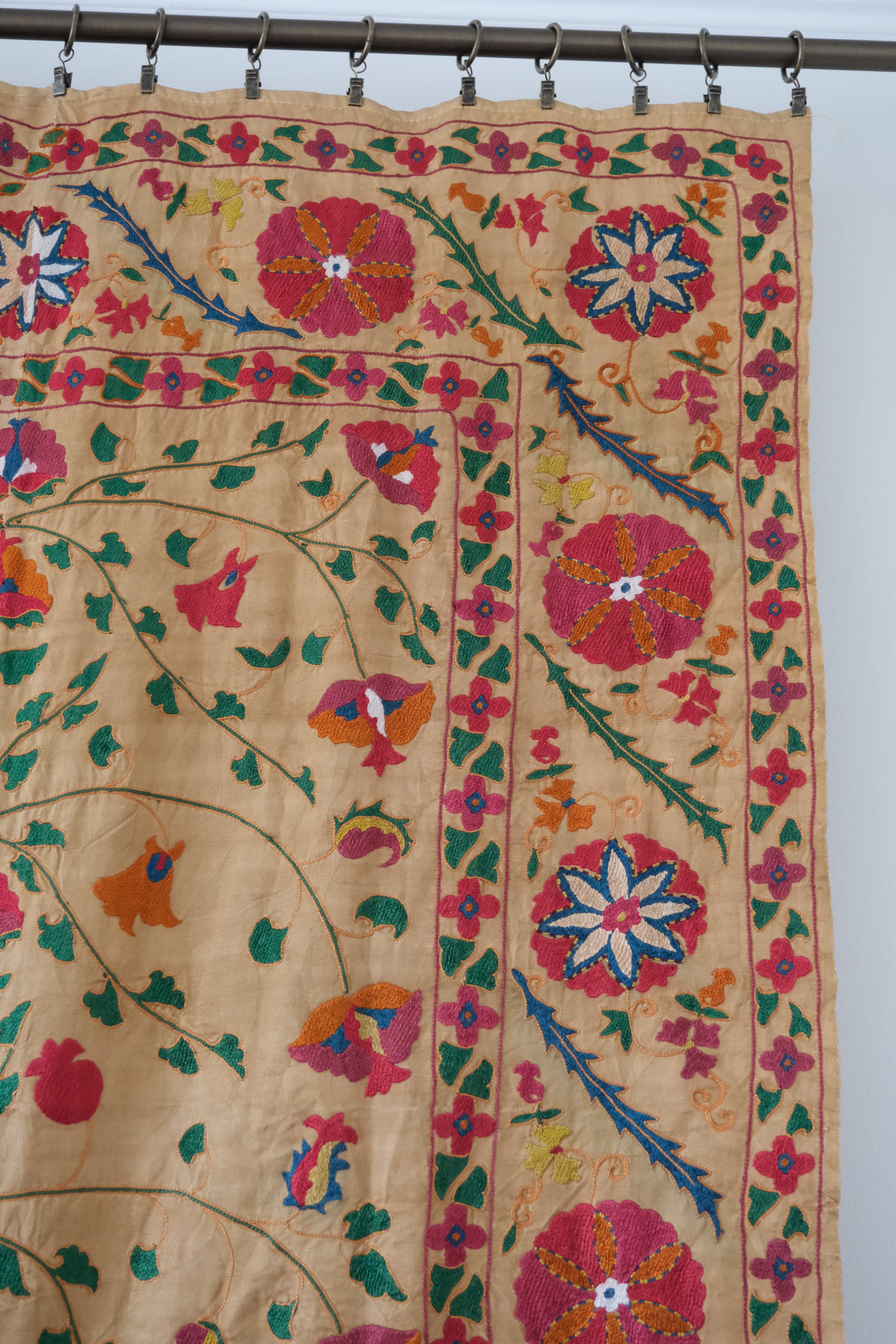 Antique suzani wallhanging, embroidered antique textile, camel with pink florals, close-up