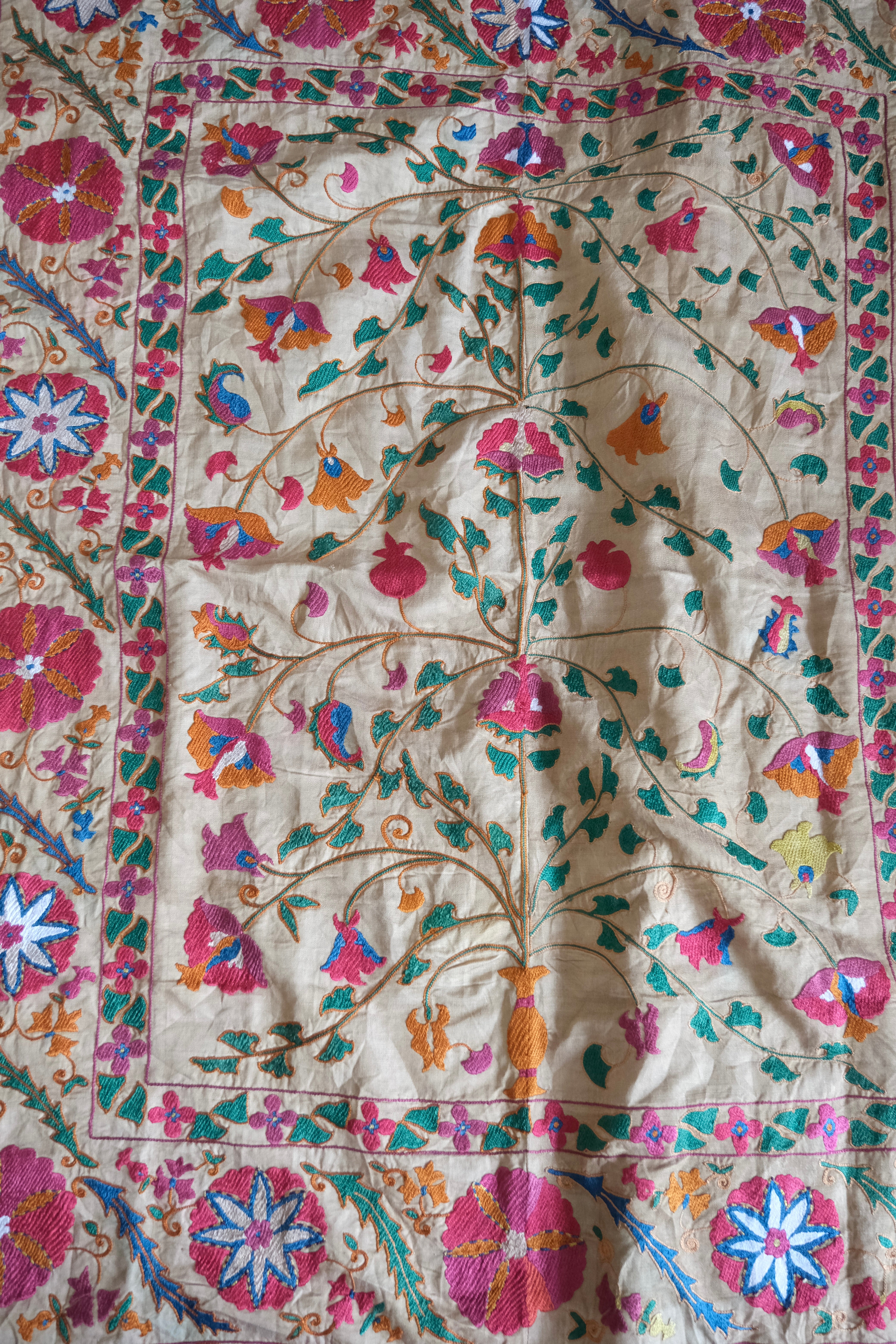 Antique suzani wallhanging, embroidered antique textile, camel with pink florals, close-up