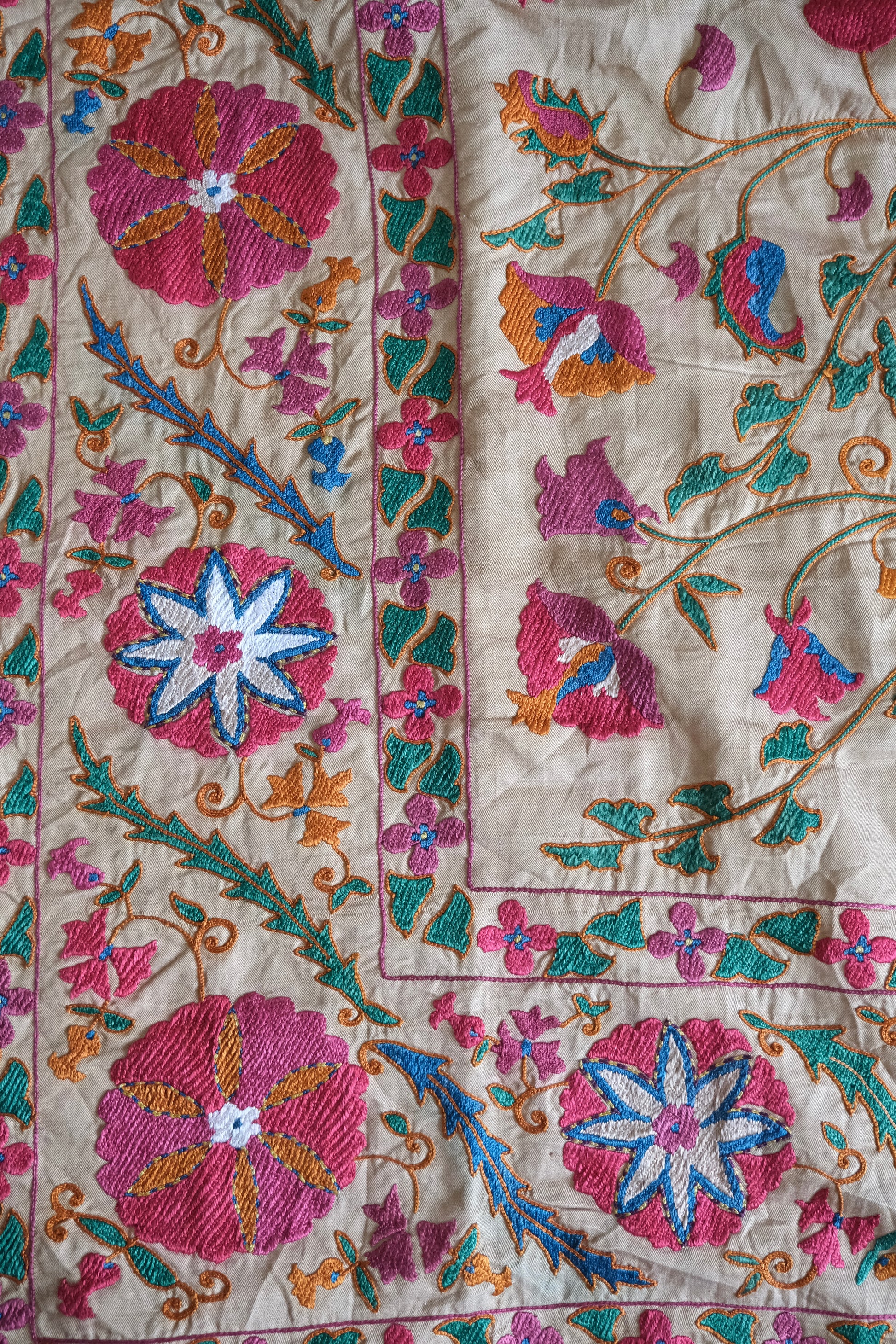 Antique suzani wallhanging, embroidered antique textile, camel with pink florals, close-up