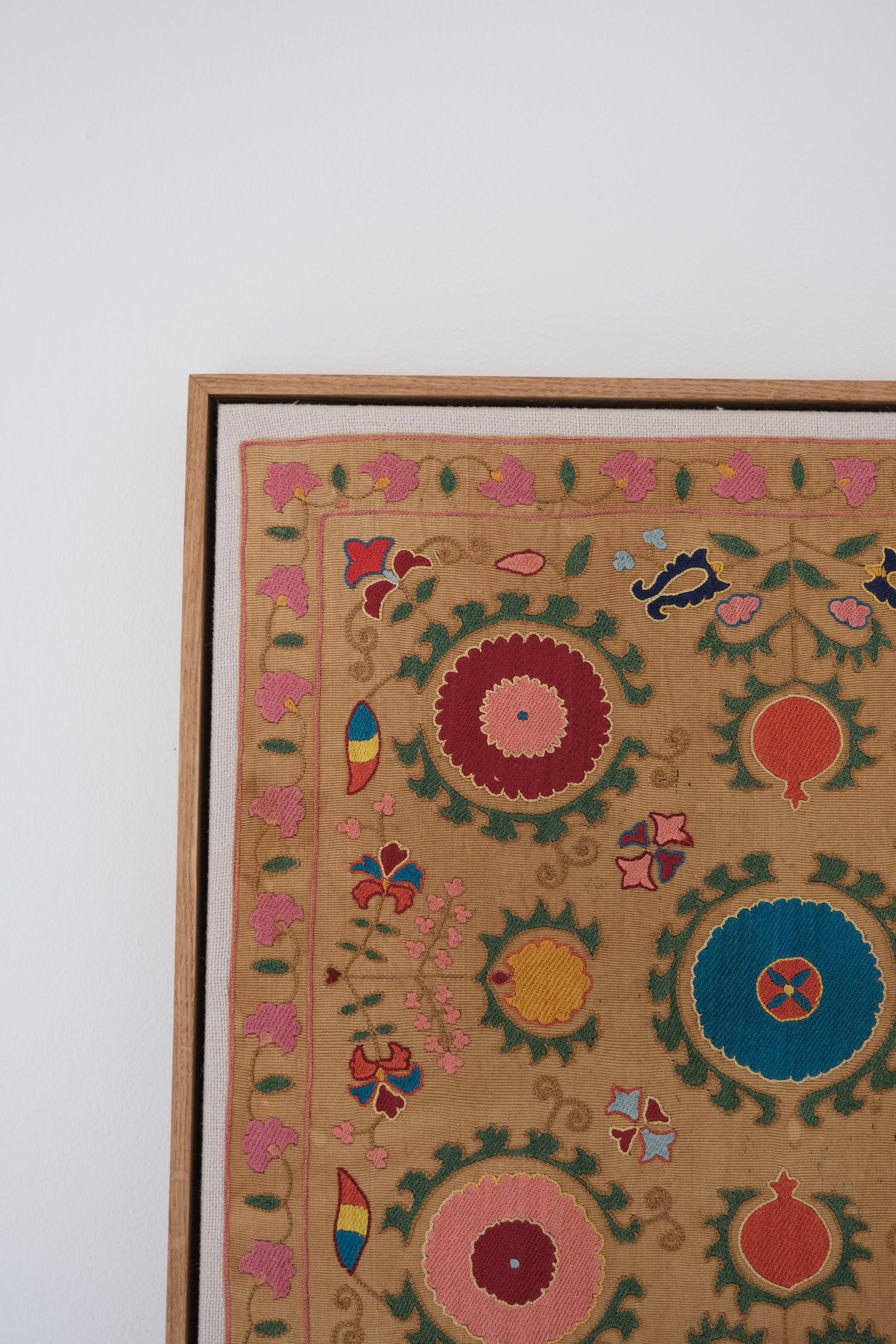 Framed antique suzani, framed textile, embroidered textile art, wooden frame, close-up