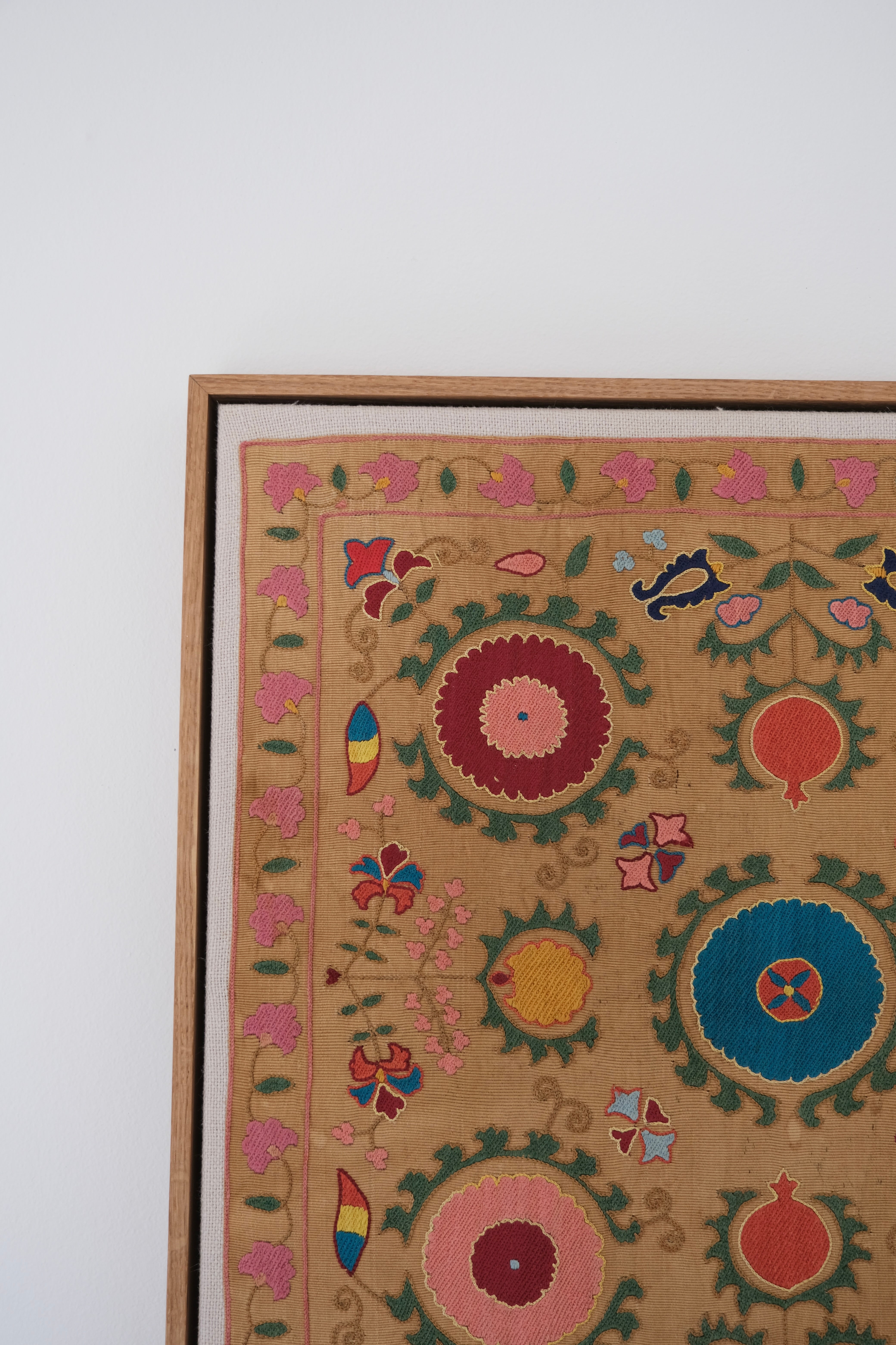 Framed antique suzani, framed textile, embroidered textile art, wooden frame, close-up