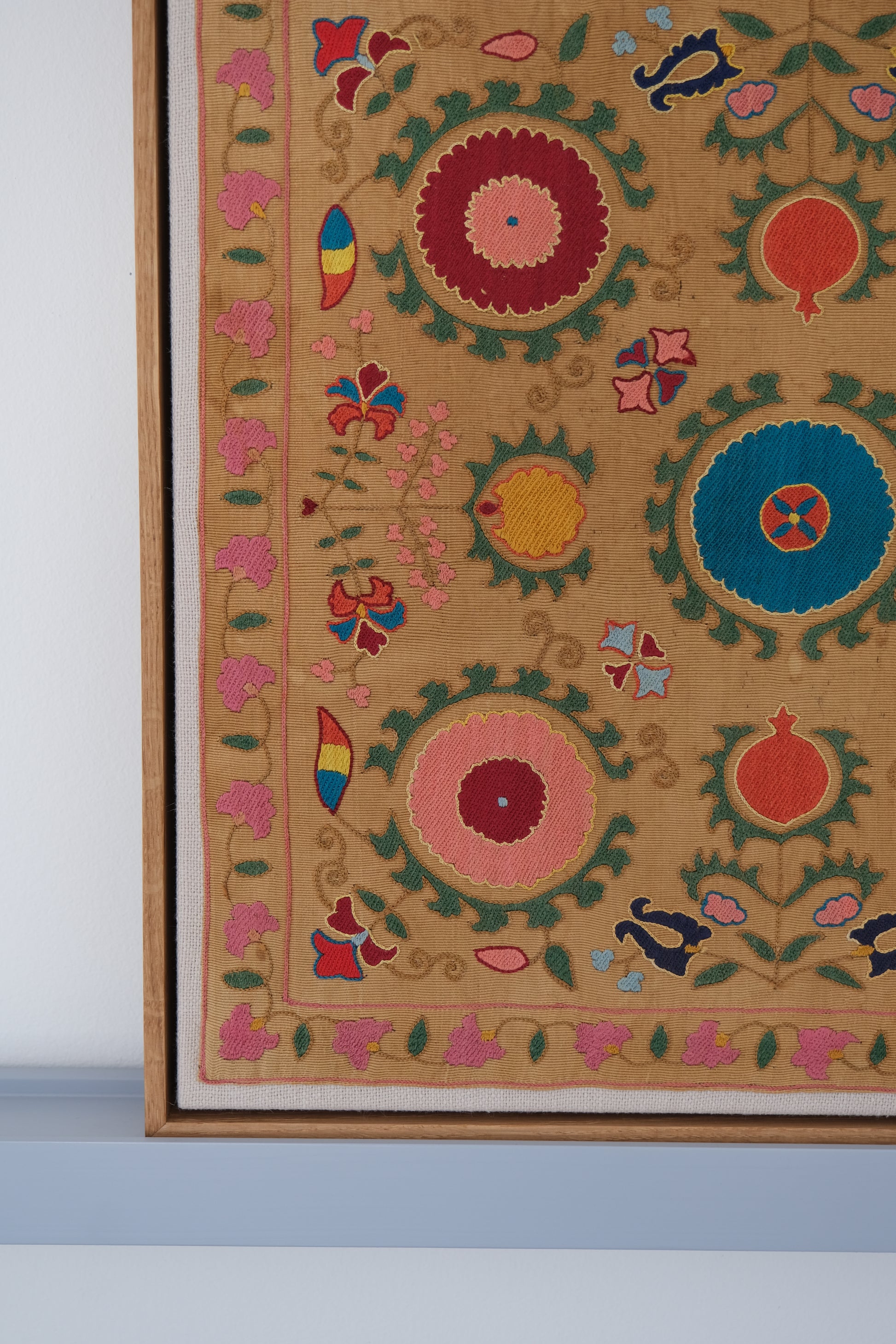Framed antique suzani, framed textile, embroidered textile art, wooden frame, close-up