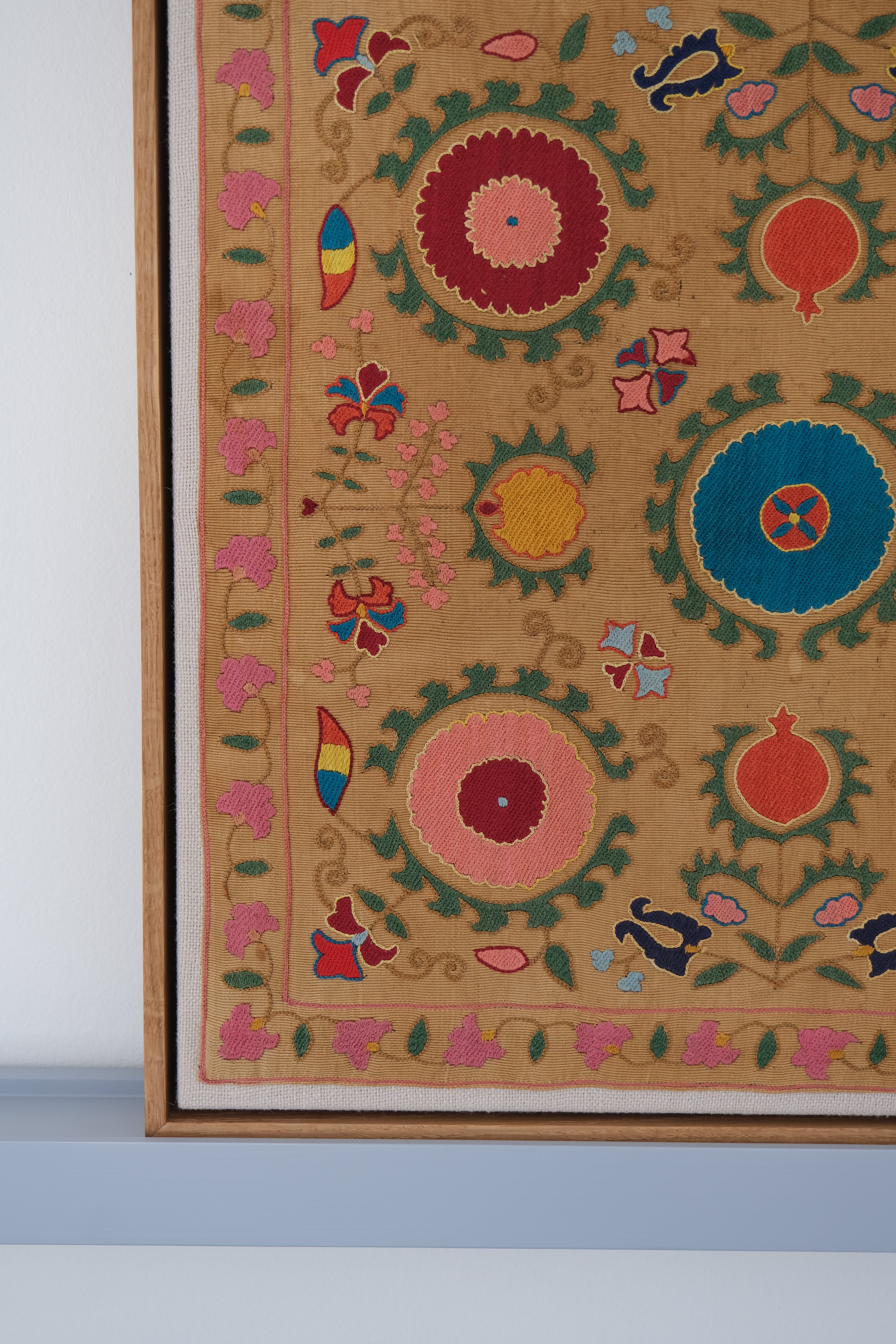 Framed antique suzani, framed textile, embroidered textile art, wooden frame, close-up