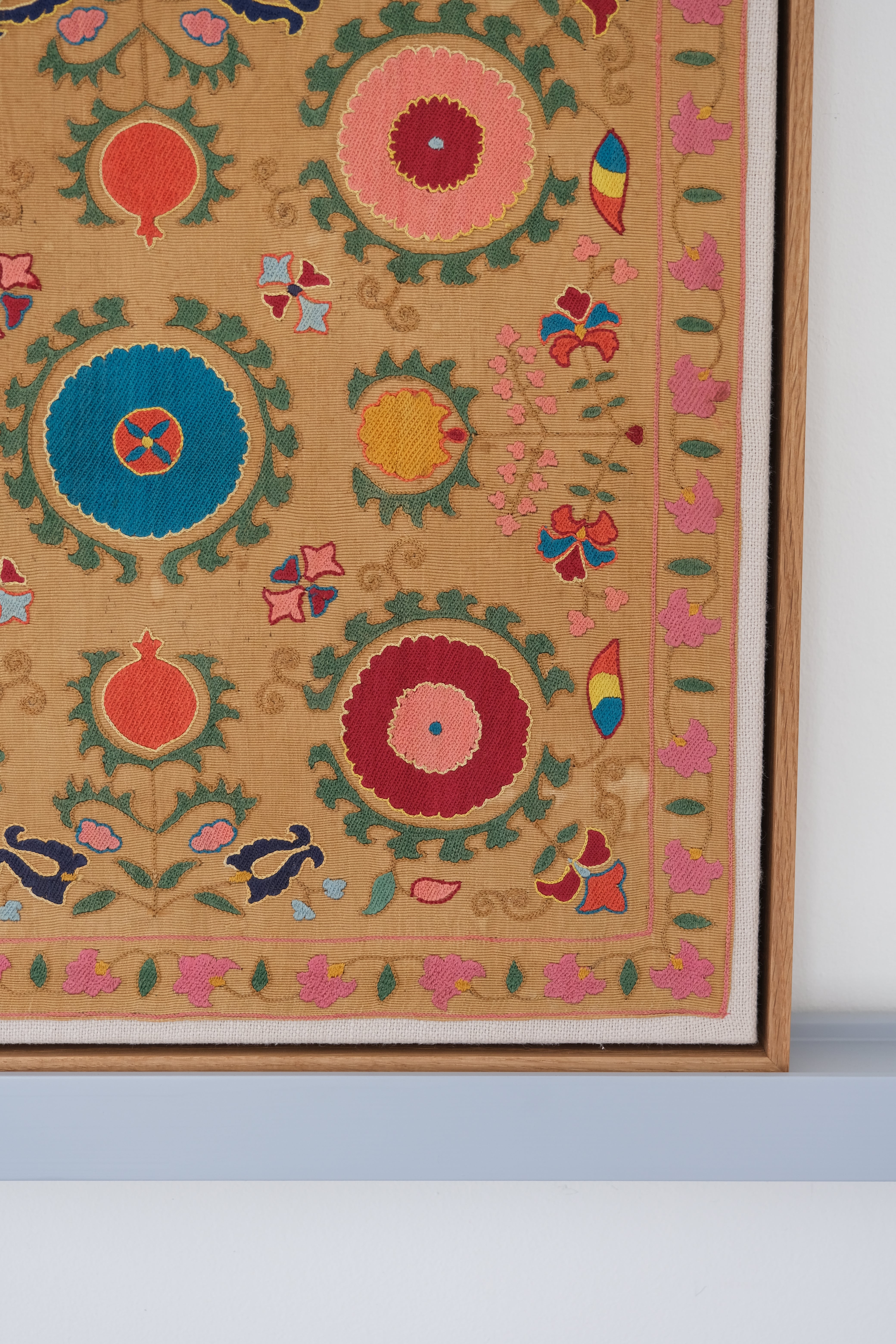 Framed antique suzani, framed textile, embroidered textile art, wooden frame, close-up