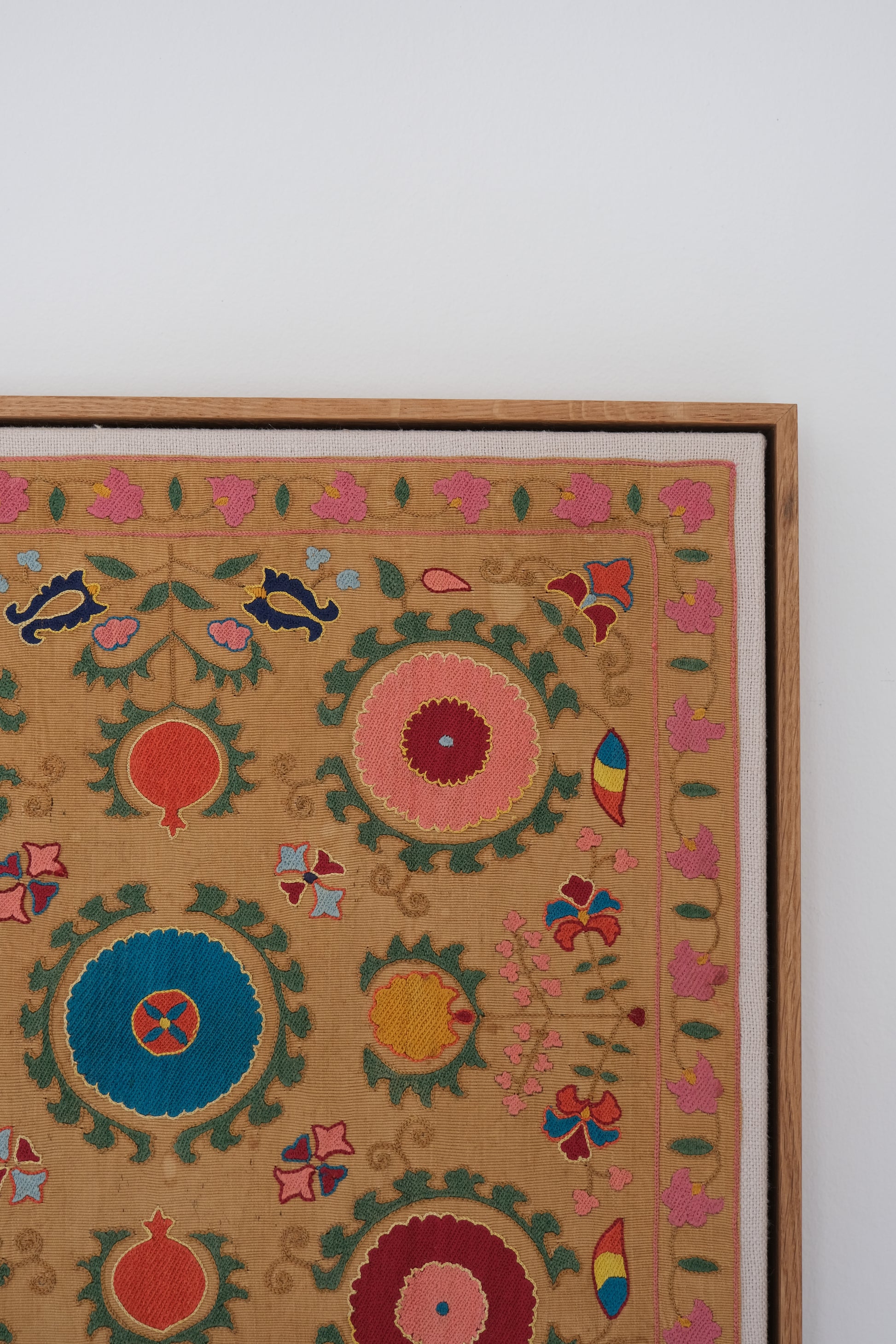 Framed antique suzani, framed textile, embroidered textile art, wooden frame, close-up